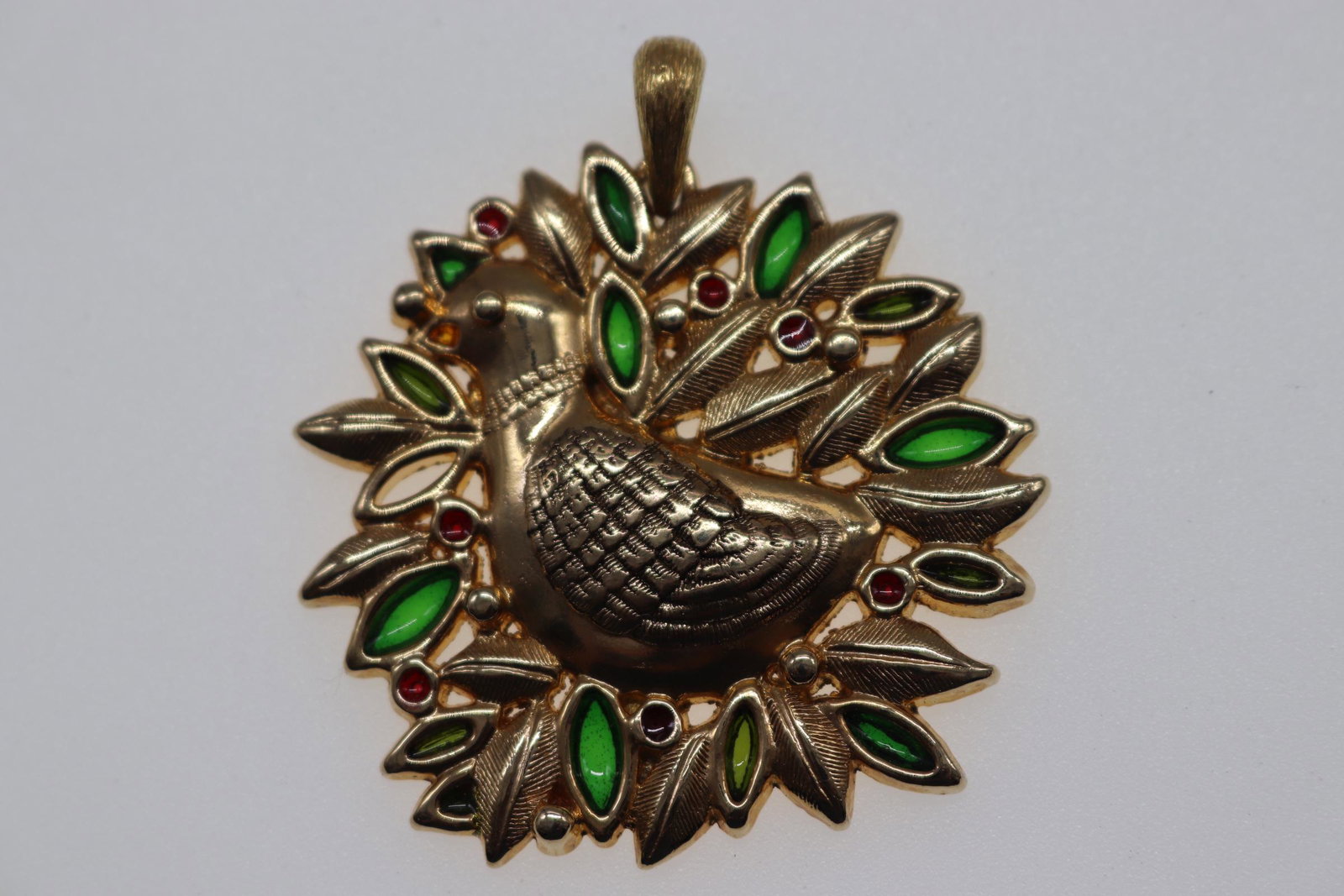 Vintage 1978 Sarah Coventry Partridge in a Pear Tree: gold toned pendant with partridge in a pear tree design, green & red stone detail, Approx. 2", see photos.