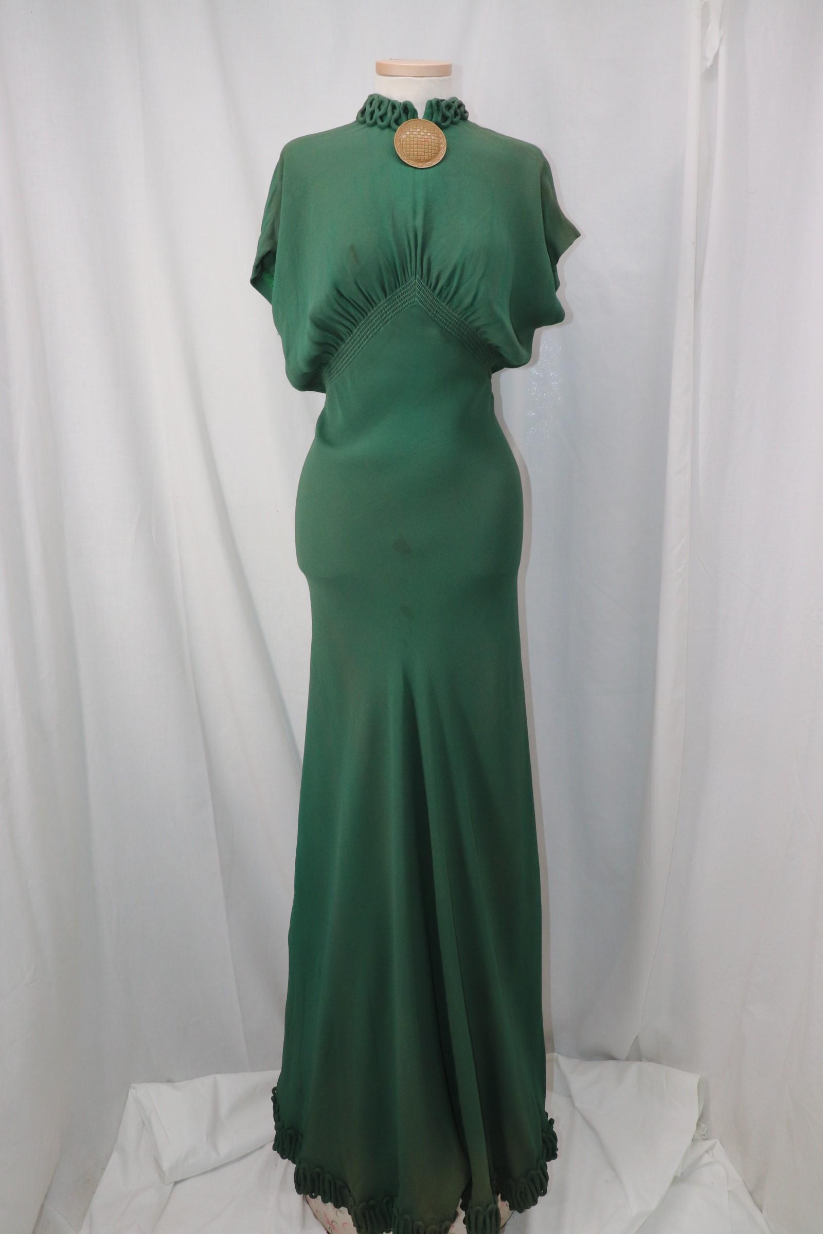 Vintage 1930's Long Green Gown: dolman cap sleeves, high round neck with corded trim, large round button embellishment at collar, high waist with smocked, inverted-v waistline, keyhole back with loop and button closure, long skirt w
