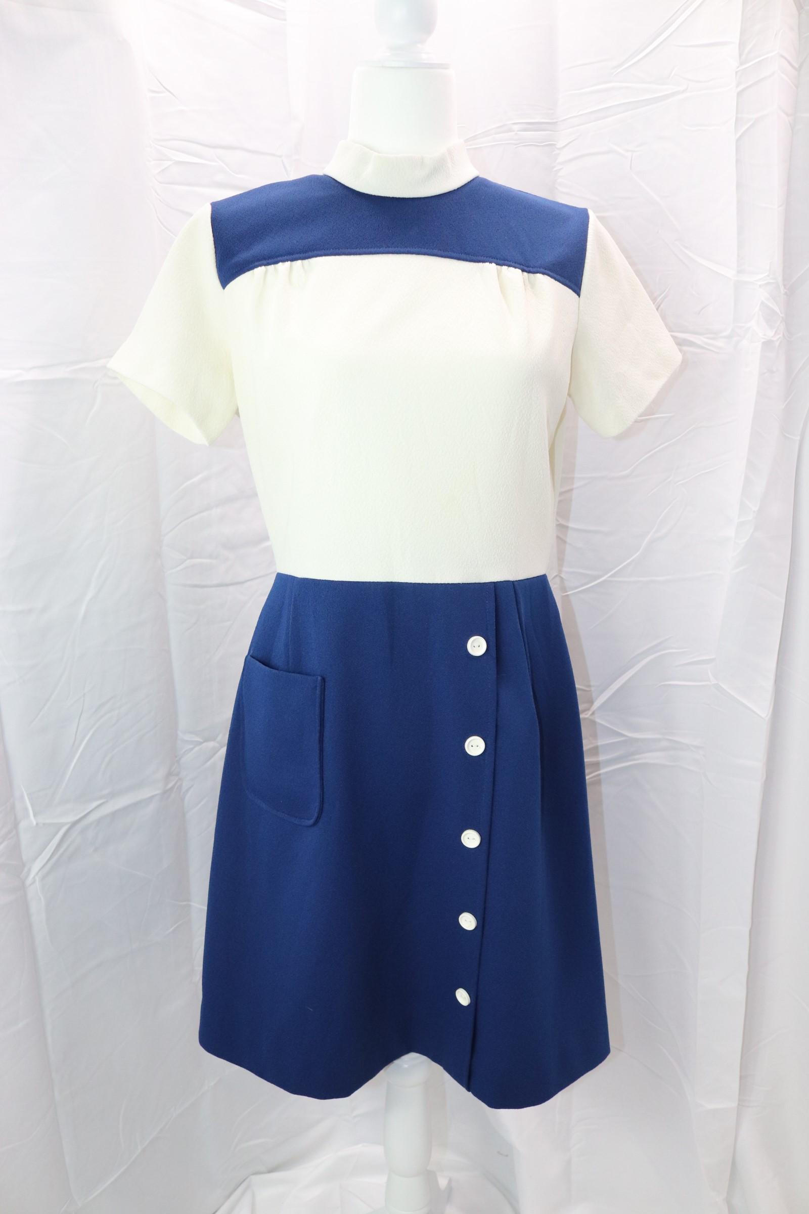 Vintage 1970's Navy & White Color Block Sheath Dress: short sleeve, high round neck, smocked bodice, sits at waist, left side button detail, large applied pocket, back zipper, poly blend, Approx. 38" Bust, 30" Bust, good condition.