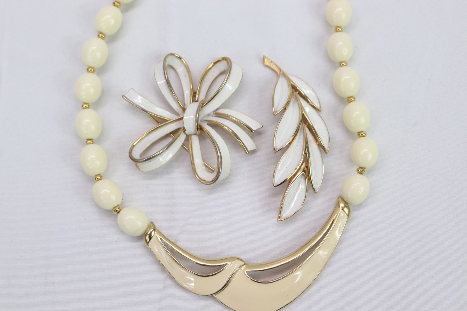 Lot of 3 Pieces of Vintage Signed Trifari Jewelry: enamel leaf brooch approx. 3", necklace approx. 16", enamel bow brooch approx. 2.5"