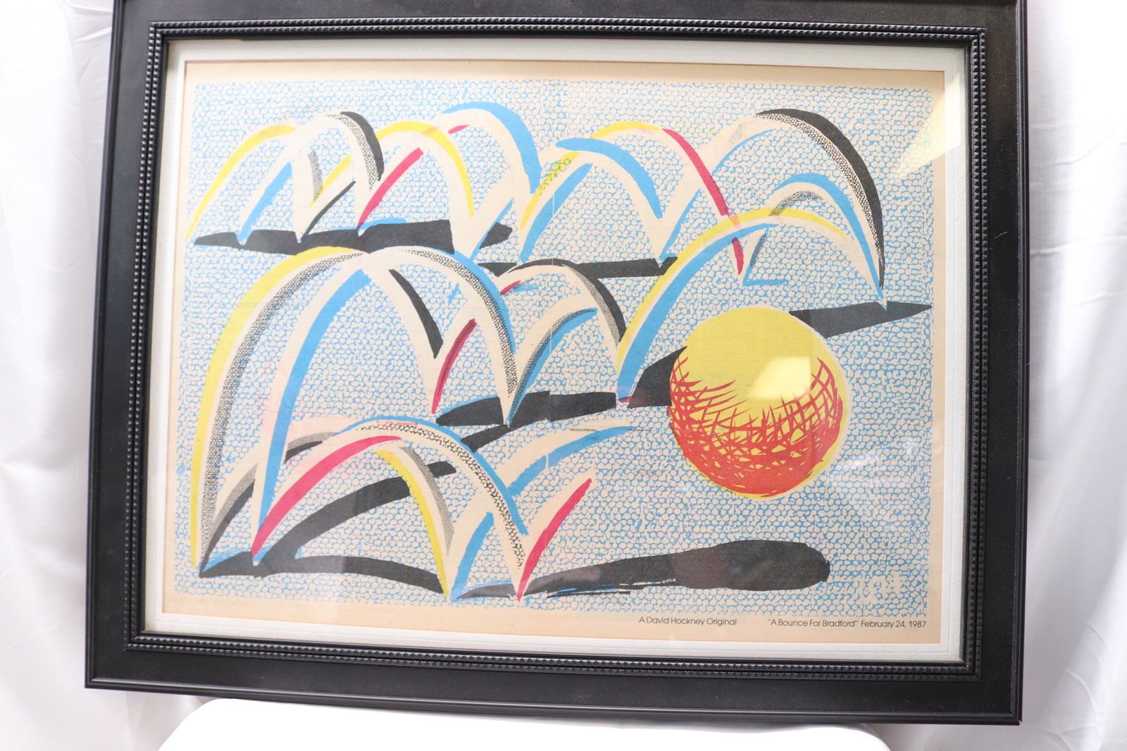 Vintage 1987 David Hockney Original Print "A Bounce For Bradford": approx. 21 x 27 including frame Hockney was born in Bradford in 1937. He was a brilliant draughtsman, the best known painter of his generation, and gained international success in his mid-20s. Hockney