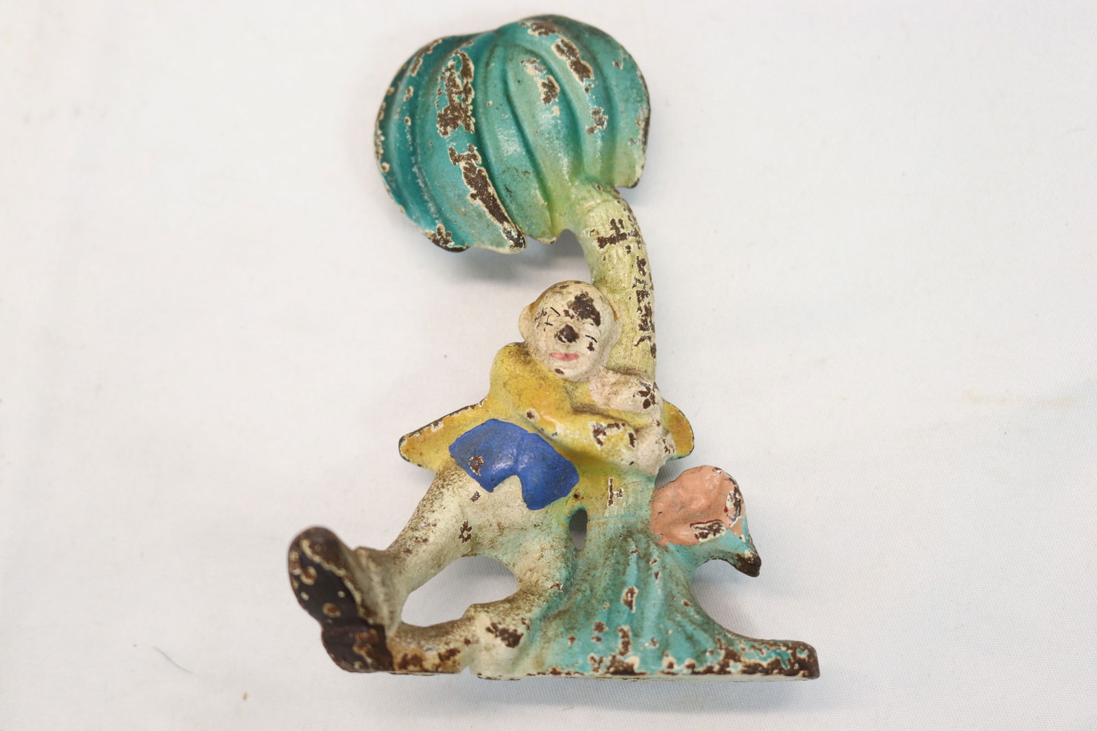 Antique Cast Iron Bottle Opener Man Holding onto Palm Tree in Drunken Stooper (1 of 4)