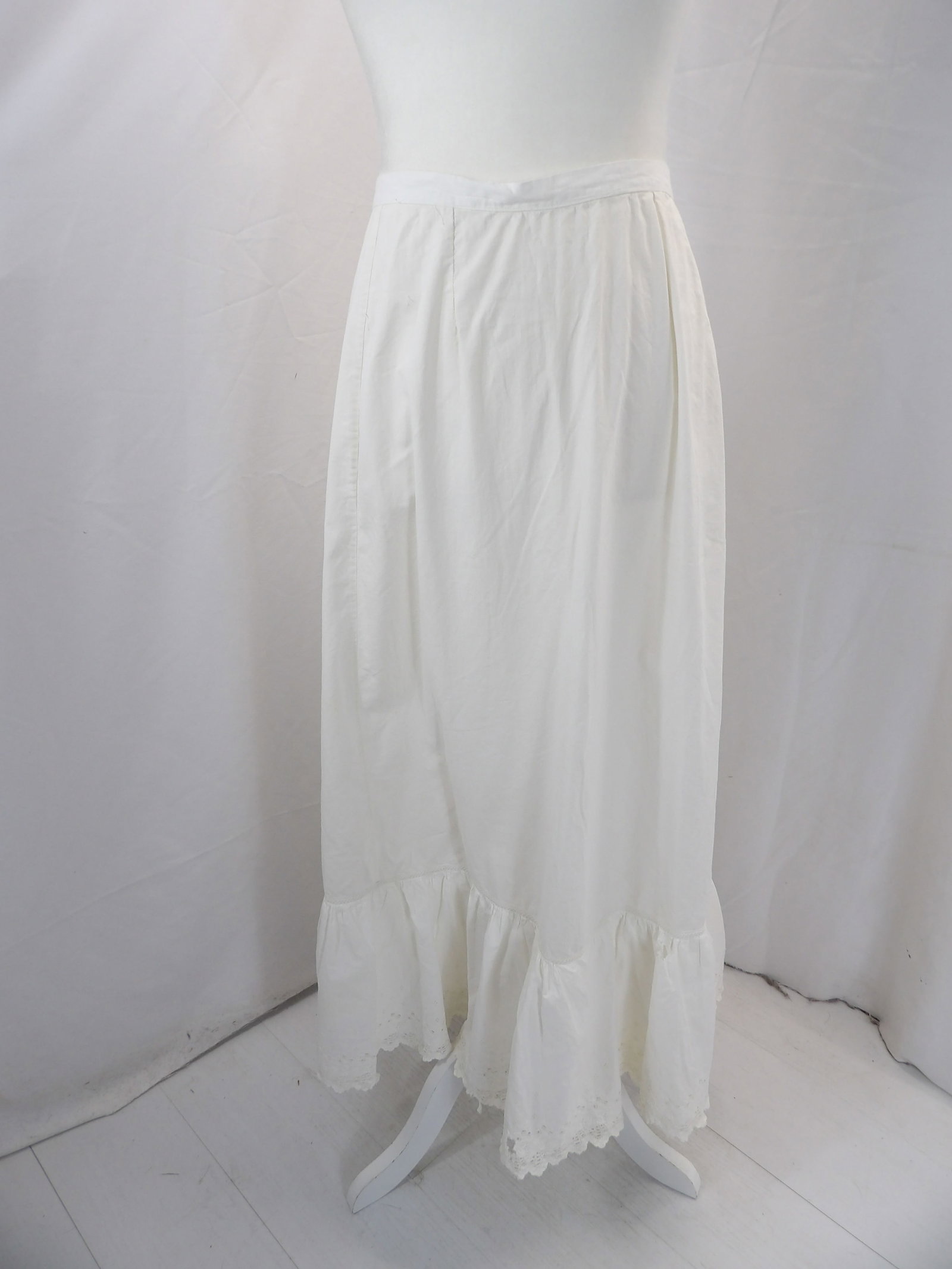 VINTAGE VICTORIAN WHITE PETTICOAT WITH EYLET TRIM: APPROX. 32 WAIST. DAMAGE AT WAISTLINE WITH A COUPLE OF SMALL HOLES & A LARGE HOLE AT THE HEM. SEE PHOTOS.
