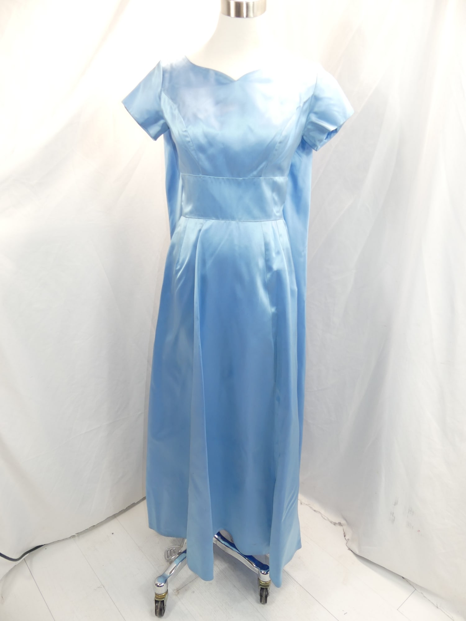 Vintage 1960's Blue Silk Satin Gown with Bow In Back: approx. 34 bust, 25 waist. Has a small stain under the bow & a few other small stains hidden in the fold, see photo's