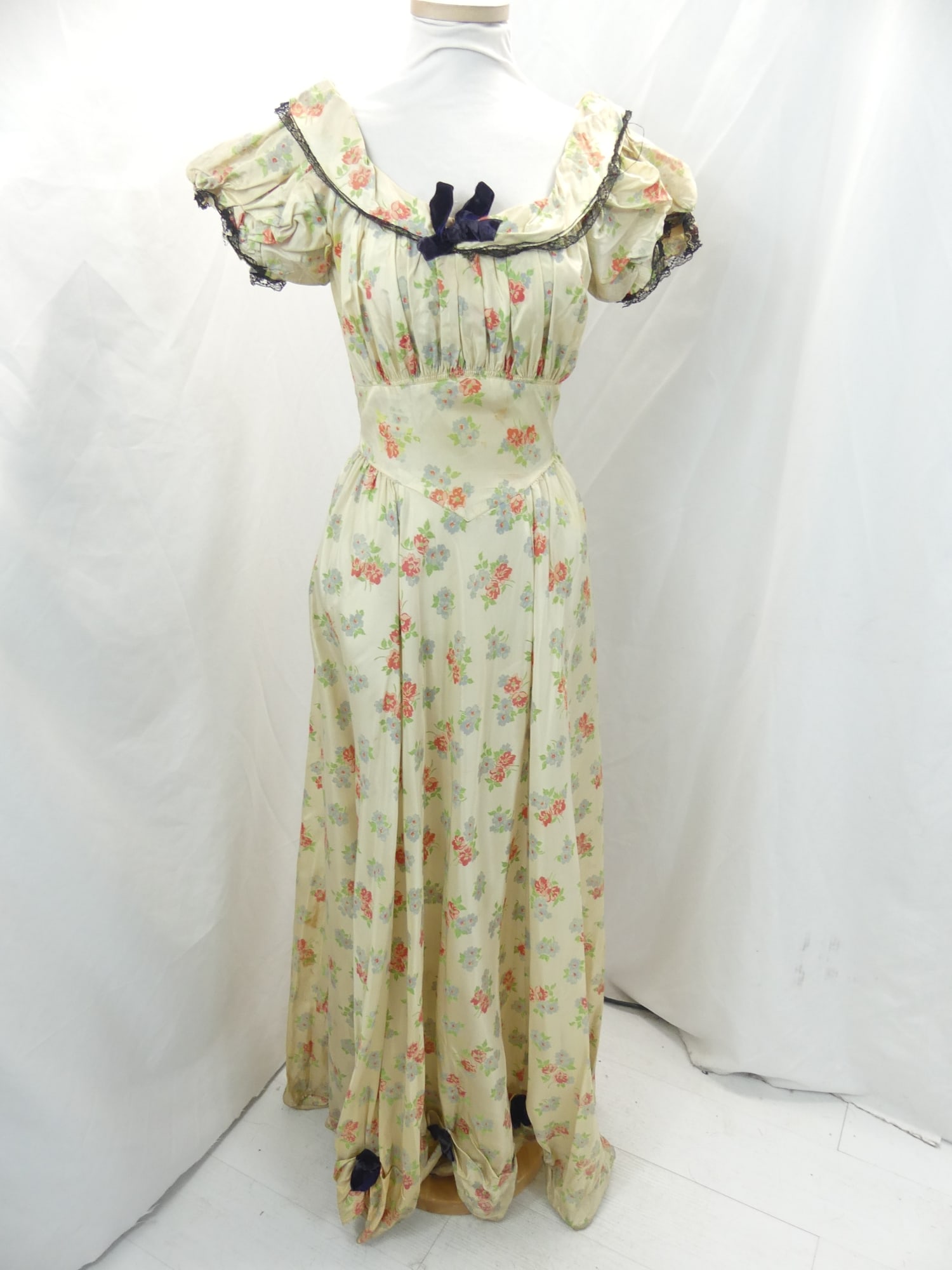 Vintage Satin Blue & Pink Floral Gown with Black Lace & Bow Trim: approx. 33 bust. 26 waist. Underarm stains, collar stains. Also has soil & stains on lower part as well as needs seam repair, see photo's