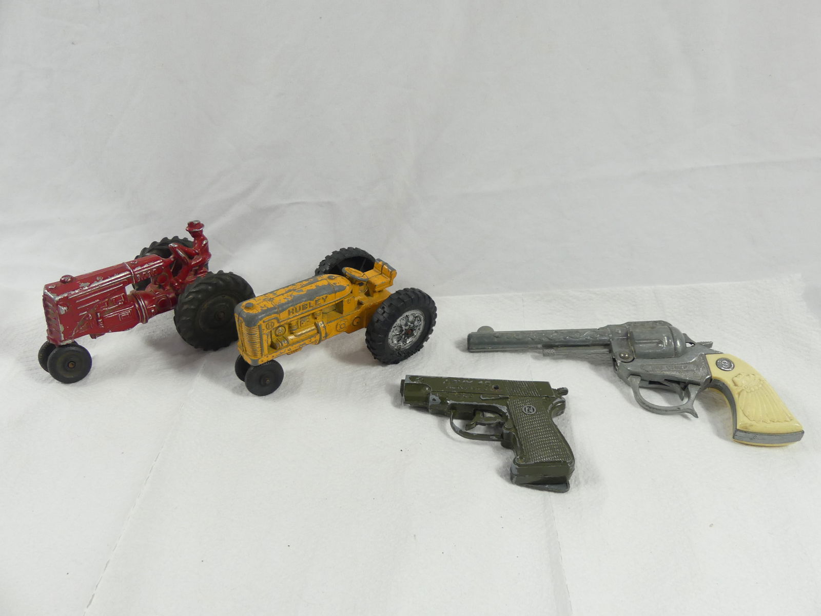 Lot of 2 Toy Cap Guns, & 2 Tractors, Hubley, Nichols, Big Chief & MM: see photo's