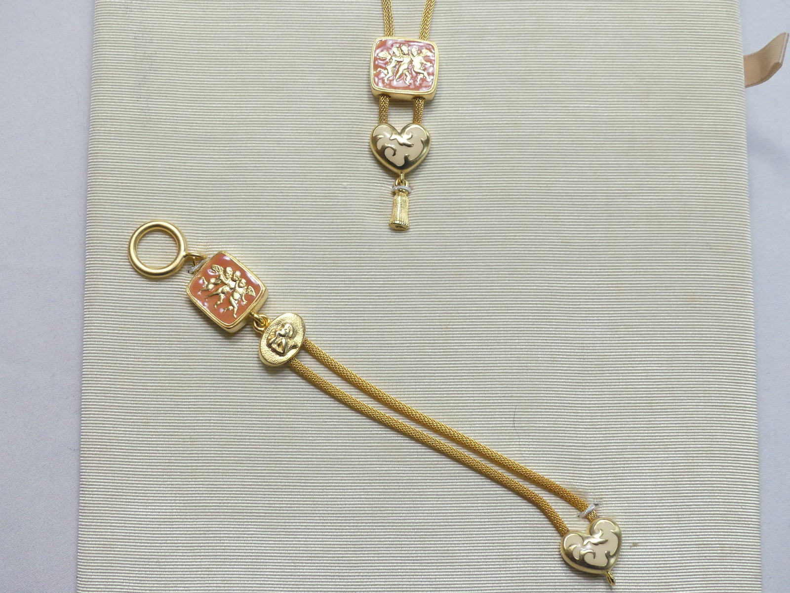 Gold Tone Enamel Cherub Necklace & Bracelet: Necklace approx. 22" w/ 2.5" pendant, bracelet 7"