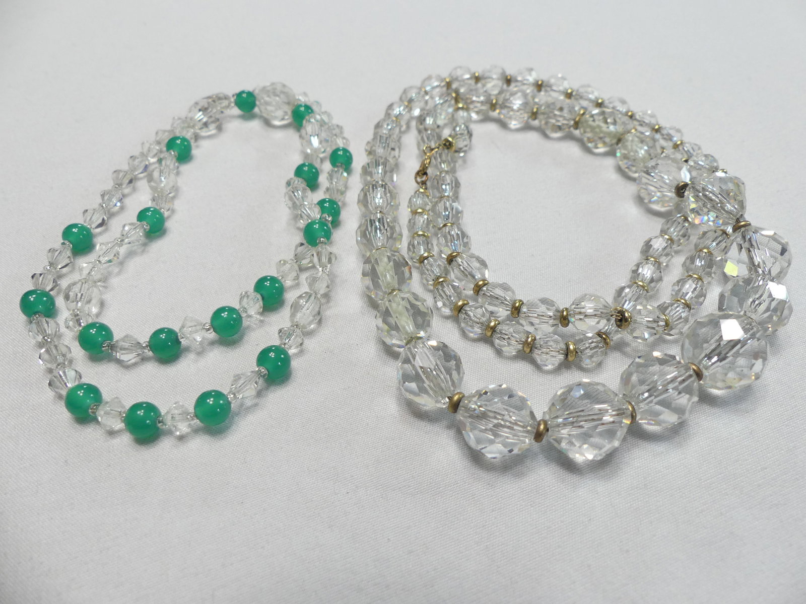 Two Vintage Czech Crystal Beaded Necklaces: 1 cut crystal & green beaded strand w/ nice box clasp set w/ tourmaline colored stone & stamped "Czechoslovakia" approx. 19'', 1 cut crystal appox. 32"