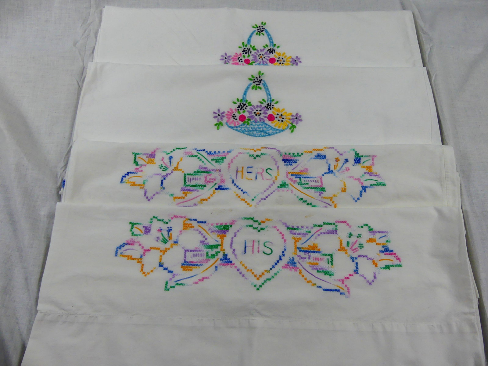 TWO PAIRS OF HAND EMBROIDERED COTTON PILLOWCASES: One embroidered his & hers, 19" x 33" & one set 20" x 31", see photos