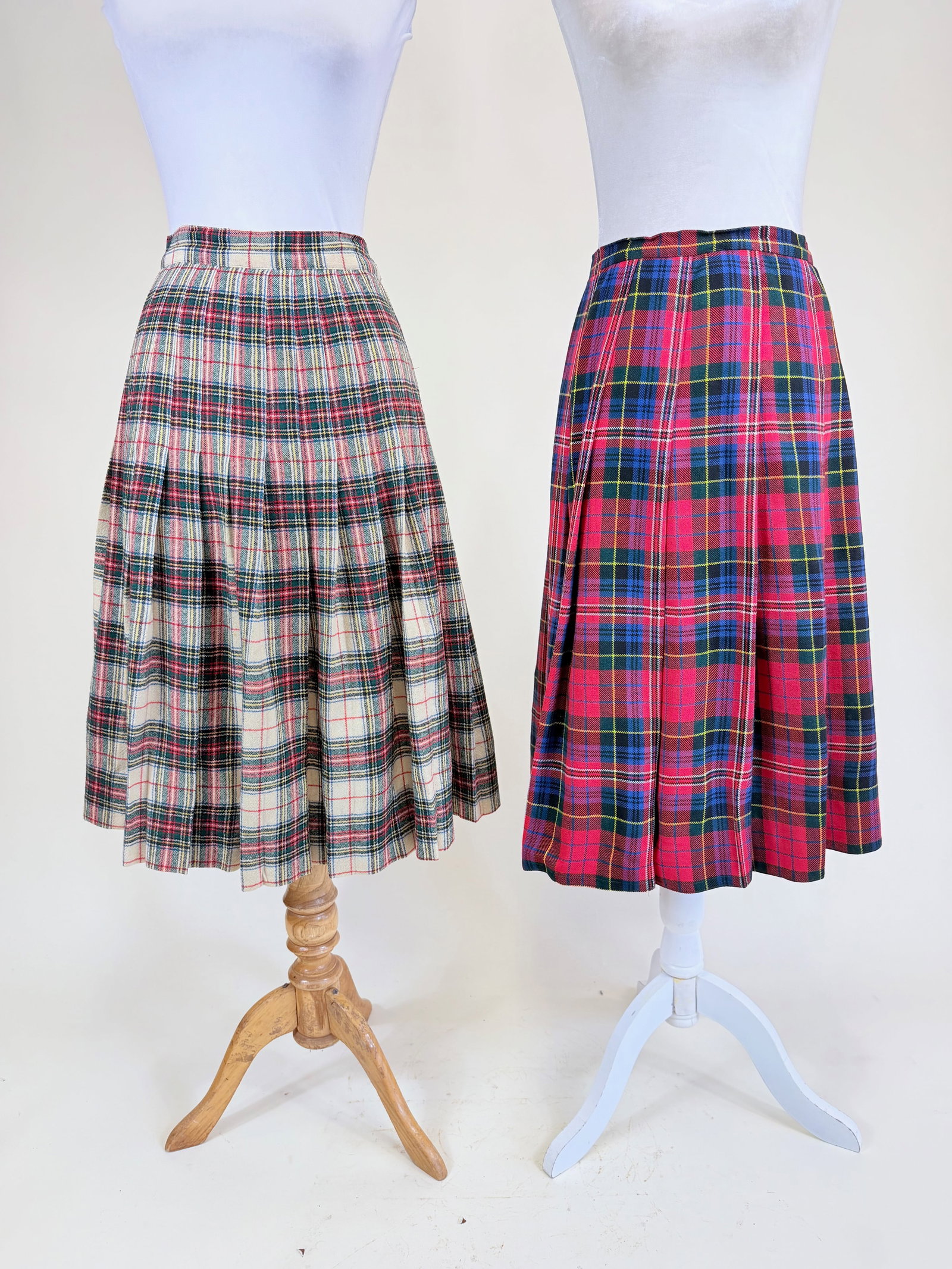 TWO VINTAGE PLAID WOOL SKIRTS: Cream, green & red, W 26", red, green & blue W 28", good condition