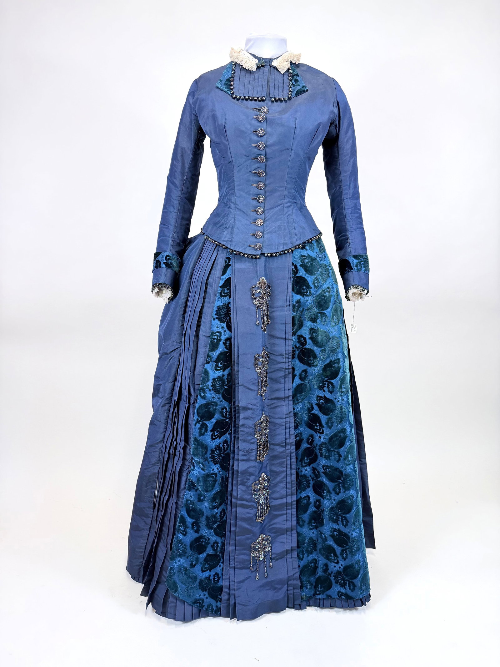 ANTIQUE FINE SILK FAILLE & VOIDED VELVET DAY DRESS, 1880s: B 31", W 24", skirt W 23", splits up to 2" in bust & shoulders, seam openings in skirt, net collar & cuff added, few missing baubles, top buttonholes split, see photos. Provenance: From the M. Estella