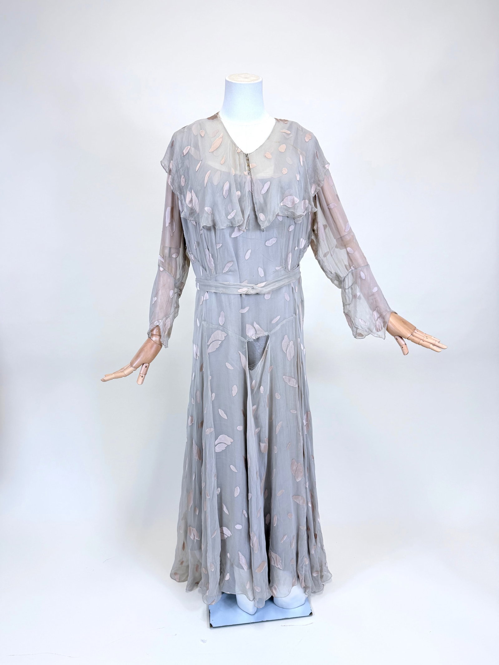 PATTERNED SILK CHIFFON EVENING GOWN, EARLY 1930s: w/ original silk satin slip, B 37", W 32", small hole at CF neckline, 2.5" x 3" hole at waist, repairs to slip, wear to belt, moth holes to skirt, see photos. Provenance: From the M. Estella Sprague C