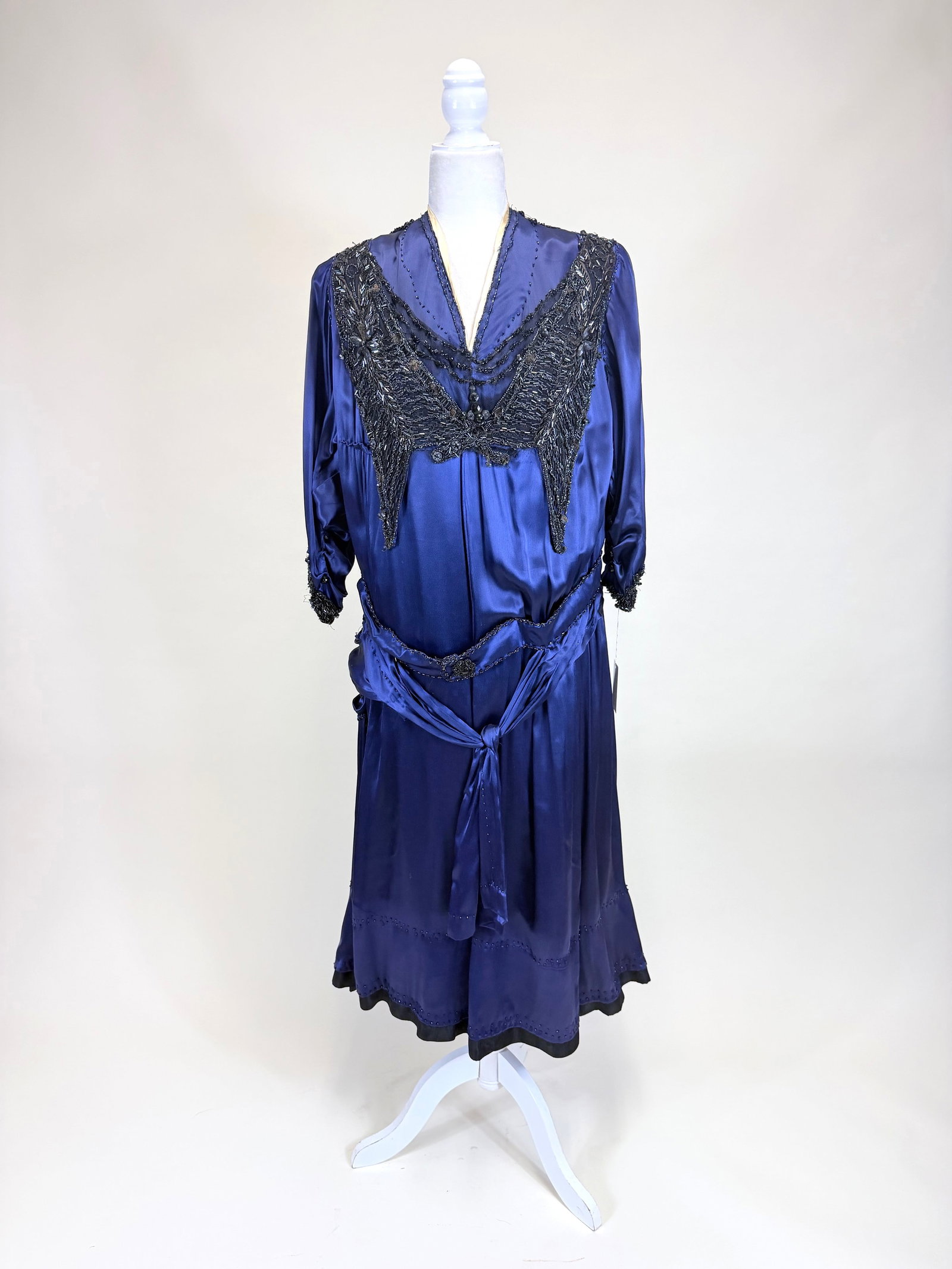 JET BEADED BLUE SILK CREPE EVENING DRESS, 1920s: B 44", W 38", odd construction, likely originally 1910s remade in early 1920s, bead disease, loose elements, seam openings, see photos. Provenance: From the M. Estella Sprague Costume Collection