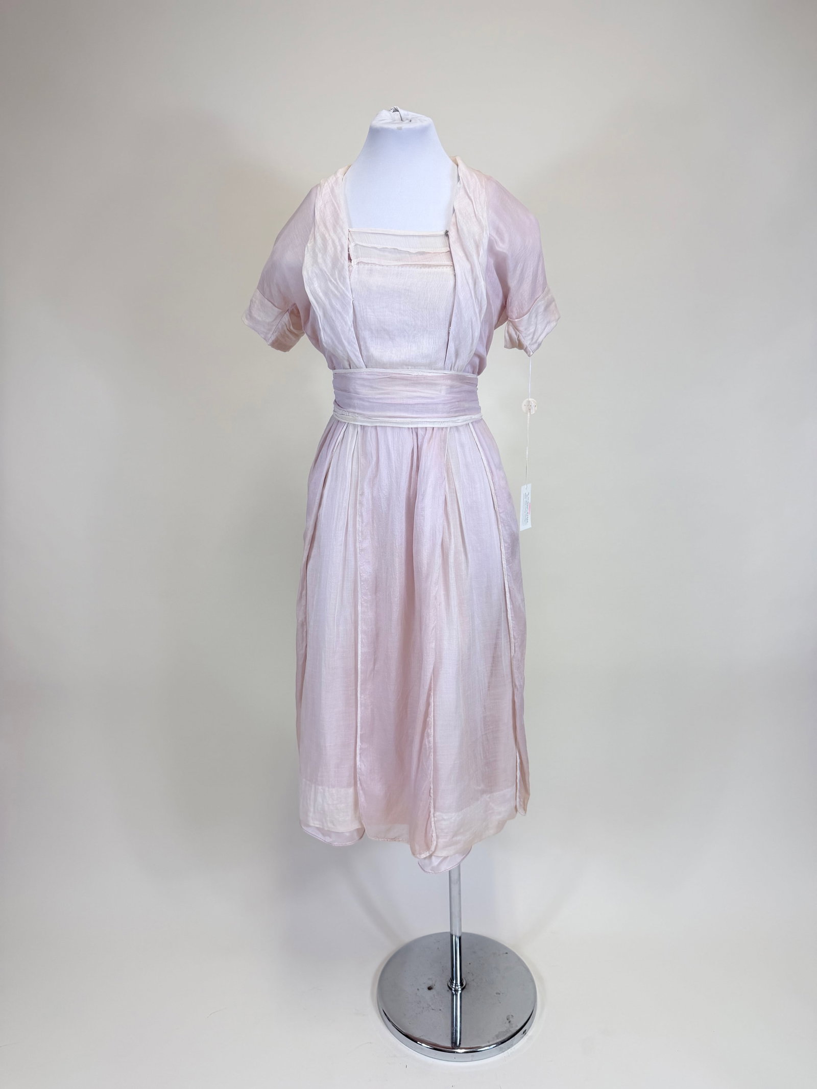 ANTIQUE LILAC & WHITE MUSLIN PARTY DRESS, c. 1918: B 30", W 24", w/ two original sashes & integrated underdress, light discoloration, good condition, see photos. Provenance: From the M. Estella Sprague Costume Collection