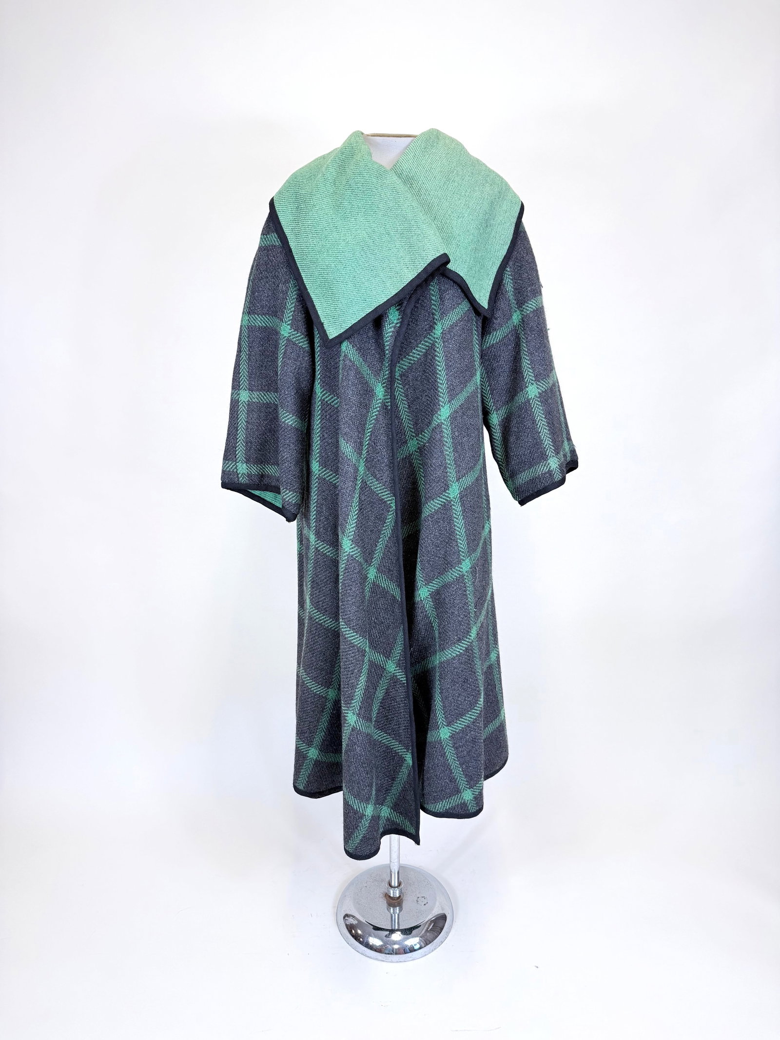 GREEN & GREY REVERSIBLE DOUBLE FACED SWING COAT, 1960s: Free front, L 42", SH-SH 19", pulls, discoloration to green, few small holes, see photos. Provenance: From the M. Estella Sprague Costume Collection