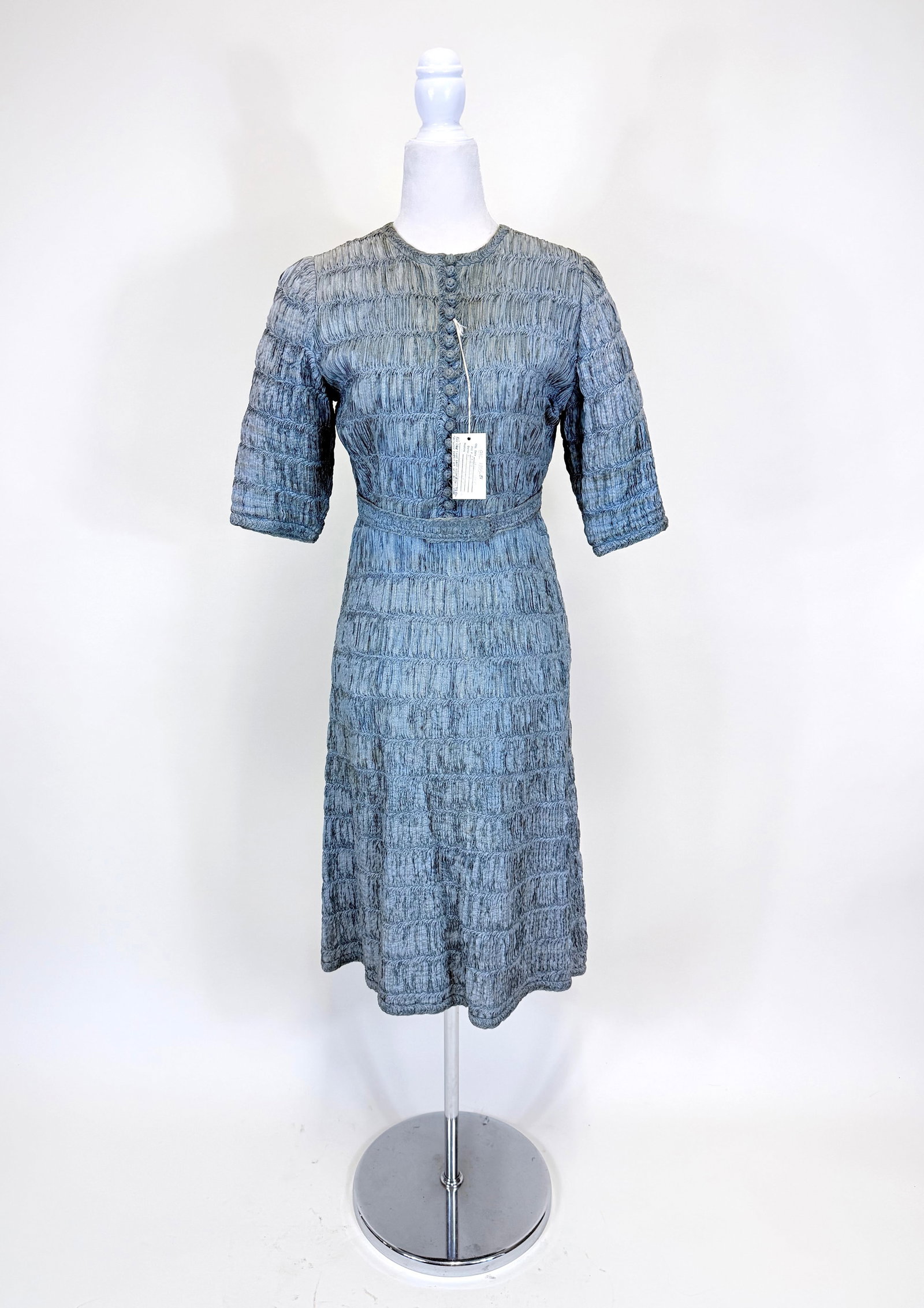 DUSTY BLUE RIBBON WORK DAY DRESS, LATE 1940s-EARLY 1950s: B 37", W 28", includes original ribbonwork belt. Some discoloration & spot staining, see photos. Provenance: From the M. Estella Sprague Costume Collection