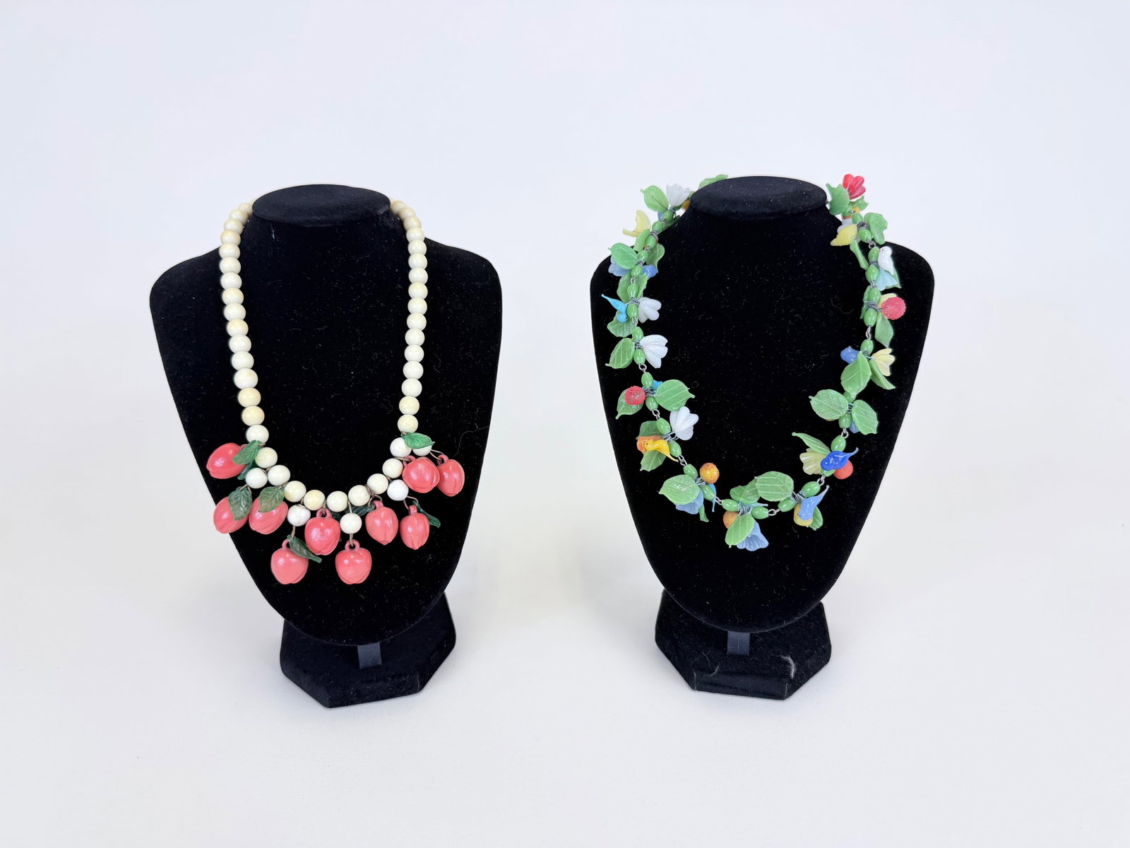 TWO GLASS OR EARLY PLASTIC BEADED CHOKERS, 1930s: Glass w/ one detached leaf motif, plastic w/ discoloration, see photos