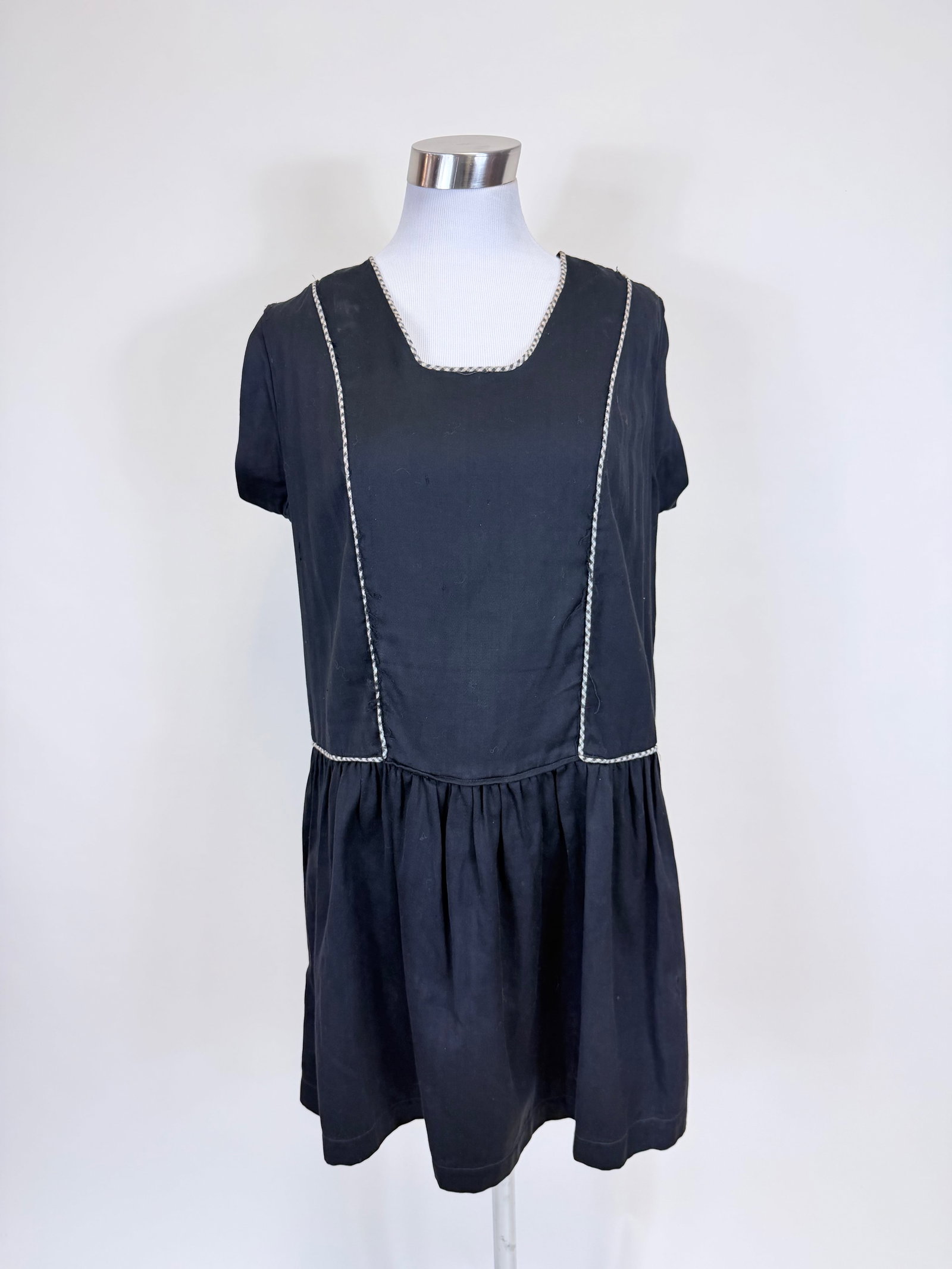 BLACK COTTON SATEEN 1920s STYLE MINI DRESS: B 38", W 40", missing closures at shoulder, few holes, wear along front piping, see photos.