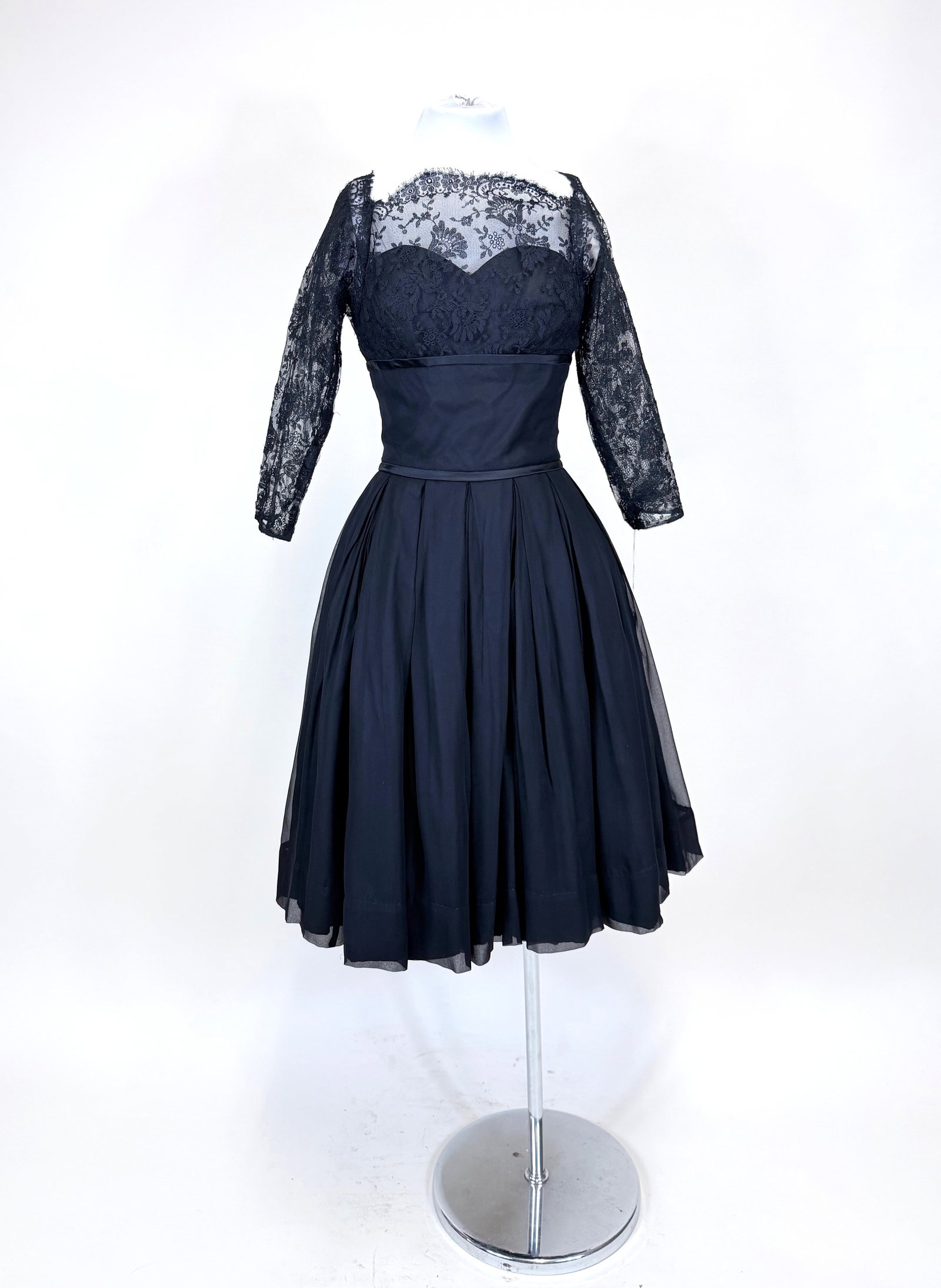 BLACK SILK GEORGETTE TAFFETA & LACE EVENING DRESS, 1955: B 34" W 24". Good condition. Provenance: From the M. Estella Sprague Costume Collection