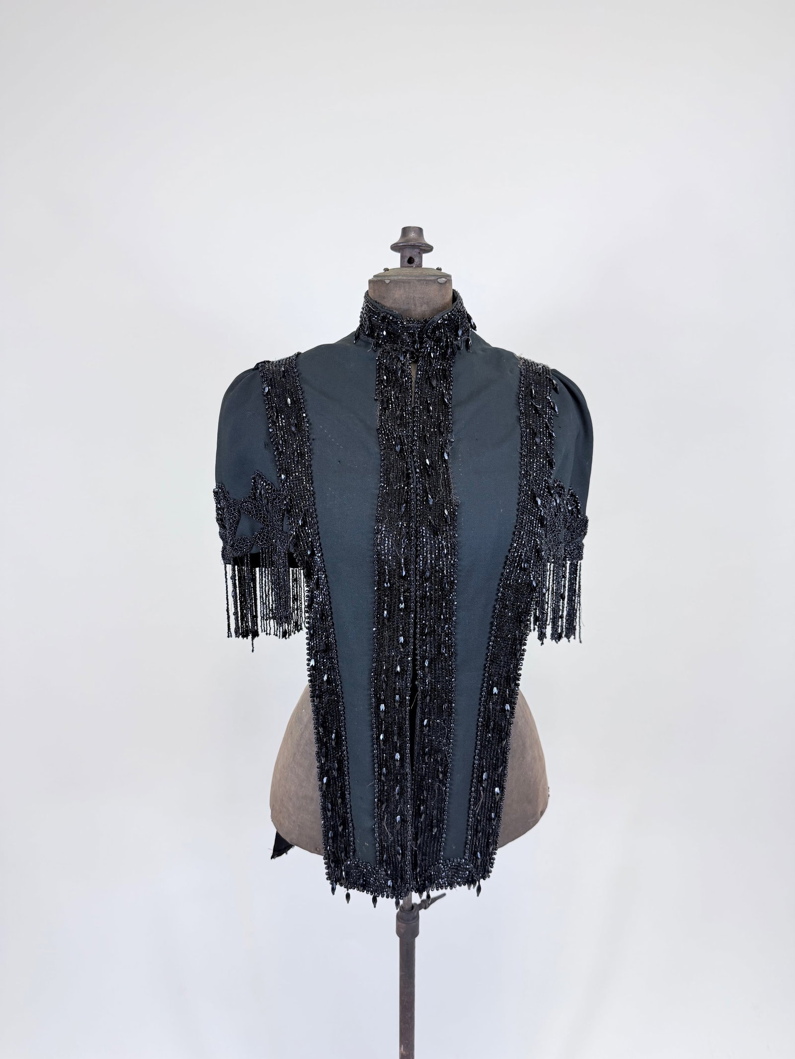 ANTIQUE JET BEADED WOOL CAPELET, 1880s: SH-SH 17", L 13"-26", bead loss, petersham torn, wear holes up to 0.5", staining, see photos