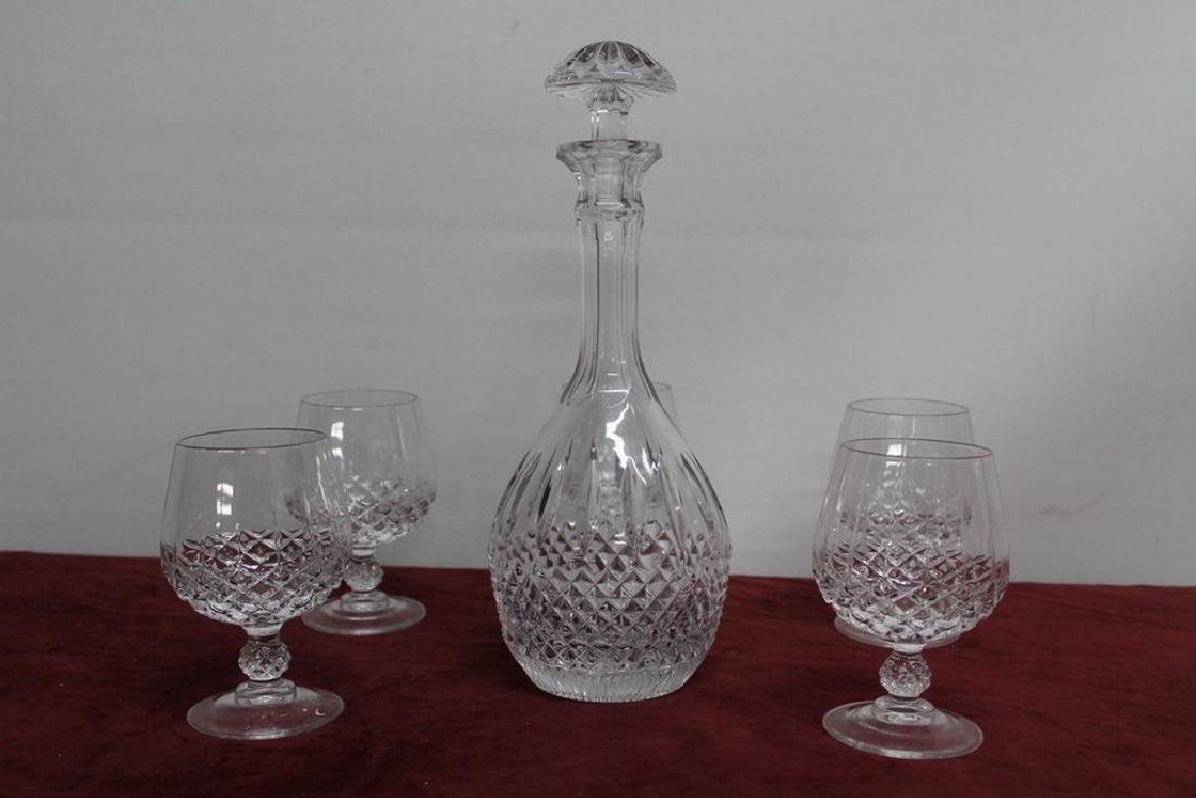 Rare Tudor crystal decanter: Latimer pattern crystal decanter by Tudor. No flea bites, chips, or any other such damage. Comes with four-and-a-spare brandy glasses.10.5 in tall (12.5 with stopper). 4.5 in diameter base.