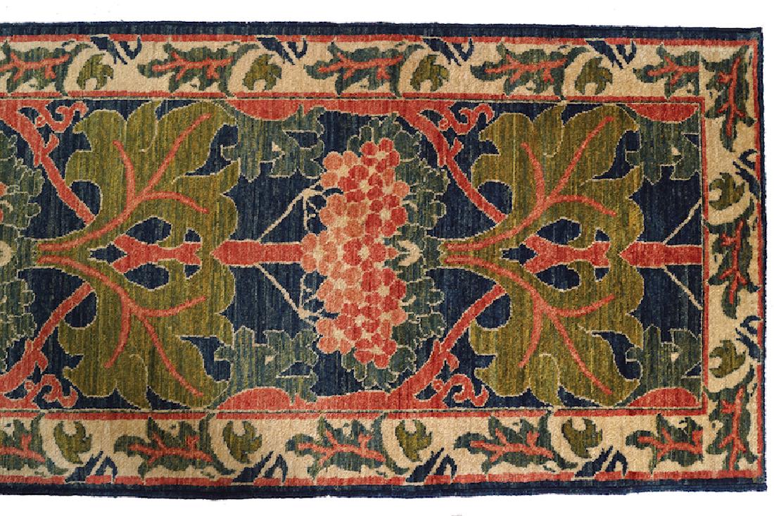 CHARLES FRANCIS ANNESLEY VOYSEY DONEGAL DESIGN RUNNER: CHARLES FRANCIS ANNESLEY VOYSEY DONEGAL DESIGN RUNNER with ivory leaves border Dimensions: 468 x 82 cm.