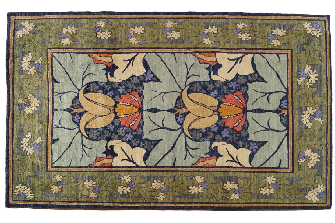 BESPOKE GAVIN MORTON AND G.K. ROBERTSON DONEGAL DESIGN: BESPOKE GAVIN MORTON AND G.K. ROBERTSON DONEGAL DESIGN CARPET, 21ST-CENTURY with ivory and blue flower heads and green border Dimensions: 214 x 321 cm.