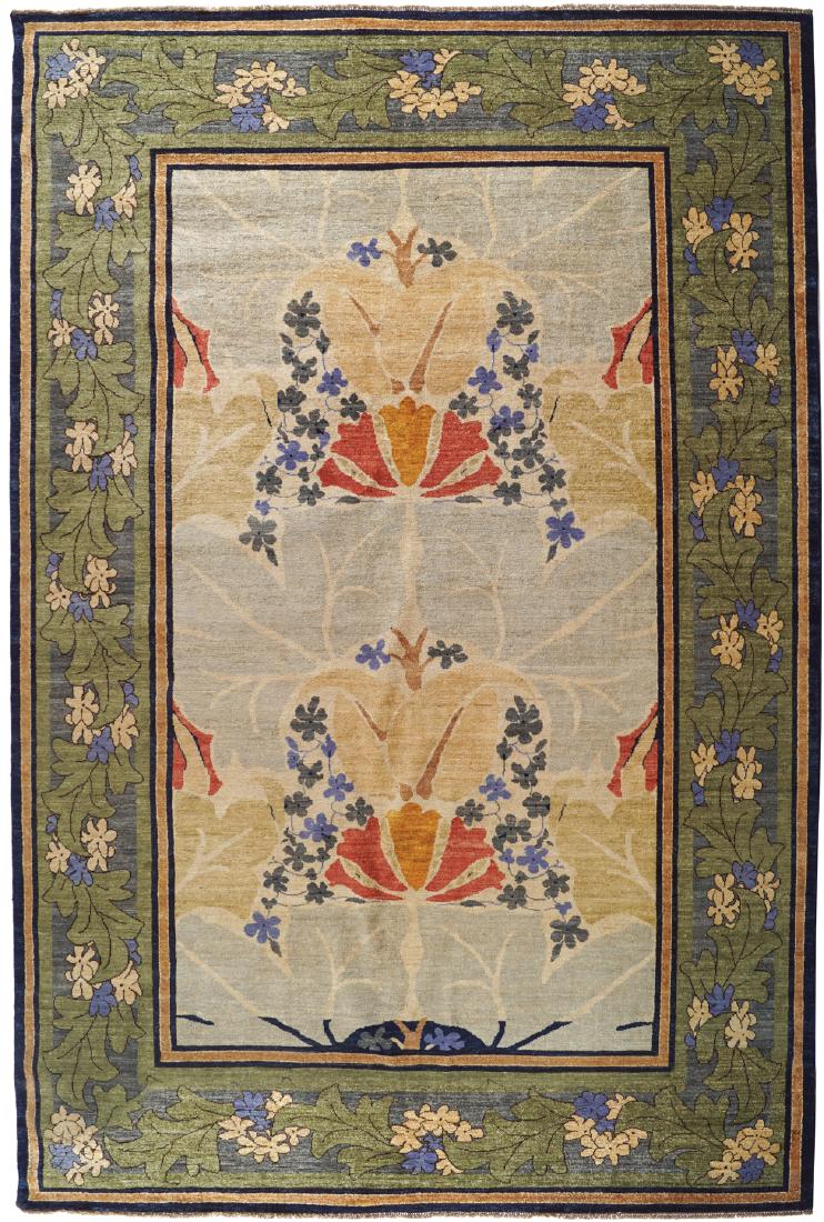 DONEGAL DESIGN CARPET, AFTER GAVIN MORTON AND G. K.: with central lotus cartouche within a green leaf decorated border Measurements: 220 x 326 cm. (7.25 x 10.75 ft.) (approx.)