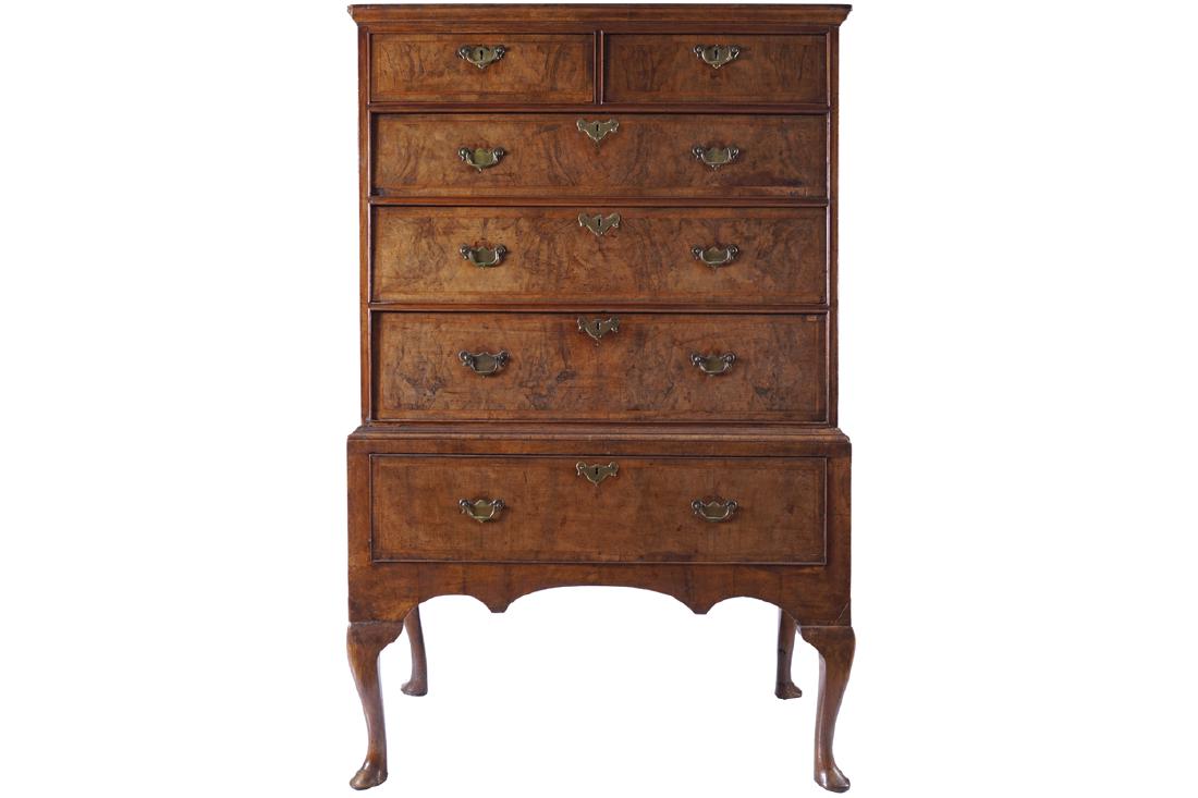 EIGHTEENTH-CENTURY WALNUT AND HERRING BONE INLAID CHEST: of two short and four long drawers, furnished with armorial brass handles and escutcheons, raised on cabriole legs, terminating on slippered feet 151 cm. high; 97 cm. wide; 56 cm. deep