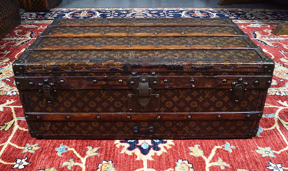 LOUIS VUITTON CANVAS STEAMER TRUNK: monogrammed M.T., Provenance: Estate of Mike Todd (movie director, married to Elizabeth Taylor) and thence by decent. 30cm. high; 80cm. wide; 51cm. deep (approx.)
