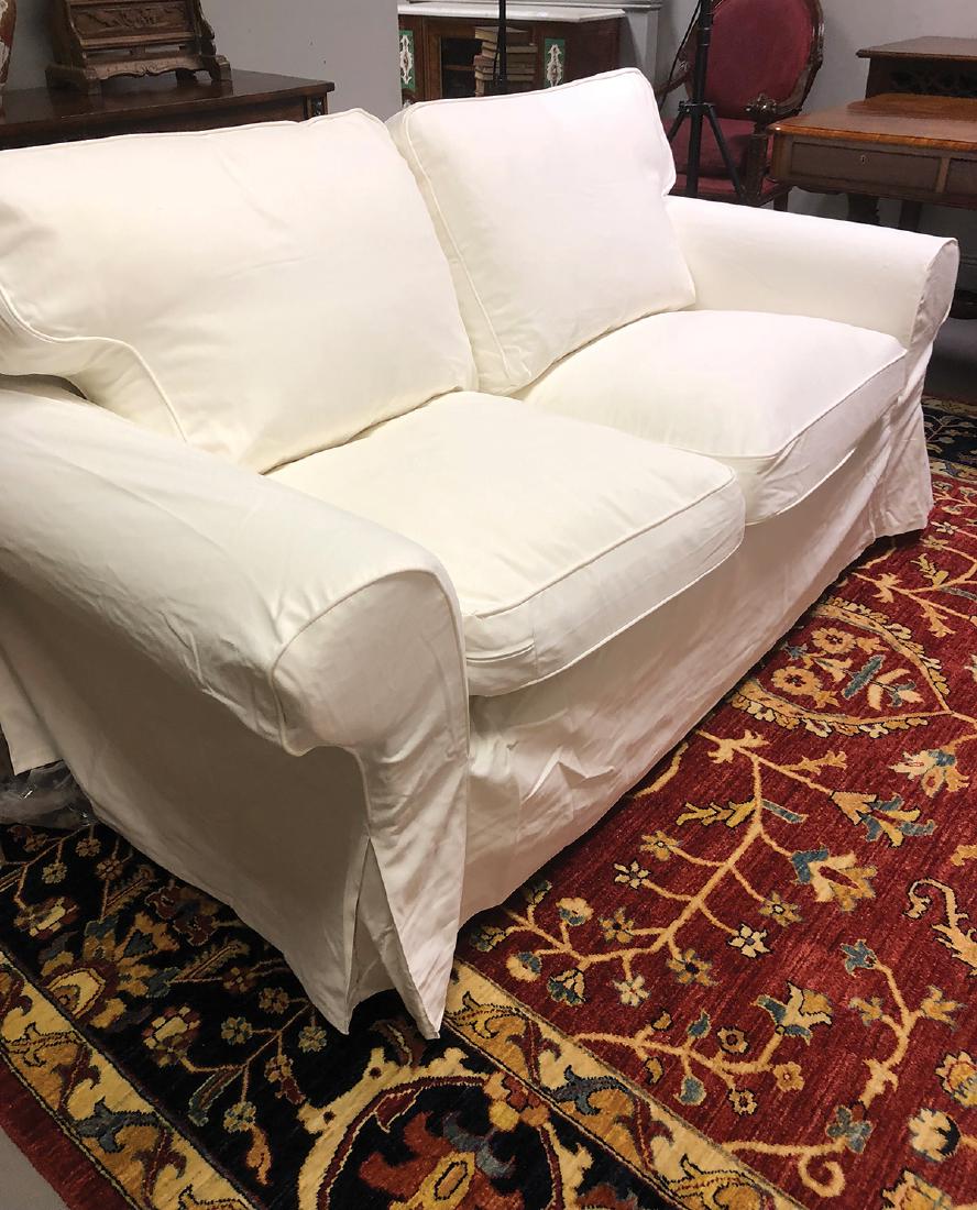 PAIR OF SETTEES: each with loose covers and cushions 190 cm. wide