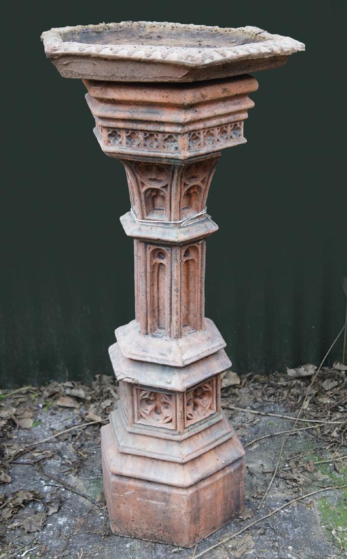 TERRACOTTA BIRD BATH: of octagonal form, raised on a Gothic arched panelled stem and shaped base 100 cm. high; 42 cm. diameter