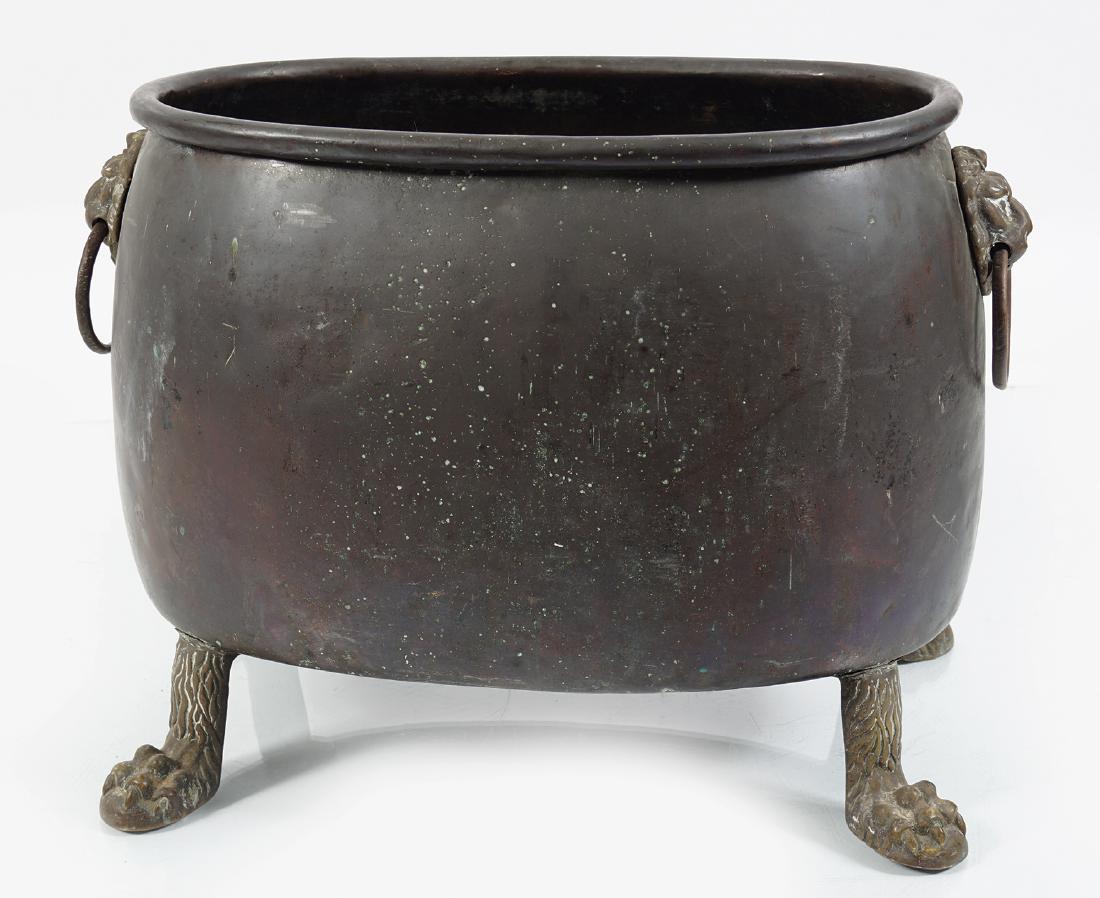 LARGE GEORGIAN COPPER LOG BOX: of oval bulbous form, raised on brass claw feet 42 cm. high; 58 cm. wide; 35 cm. deep
