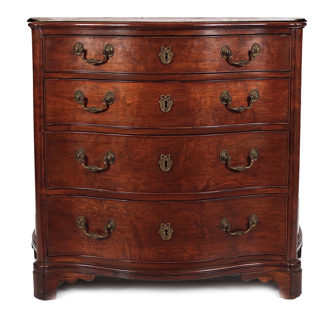 18TH-CENTURY CHIPPENDALE SERPENTINE COMMODE: circa 1770, of three drawers, furnished with ornate brass handles. This commode, after a design by Thomas Chippendale, shows a richness and subtlety of design 76 cm. high; 83 cm. wide; 44 cm. deep