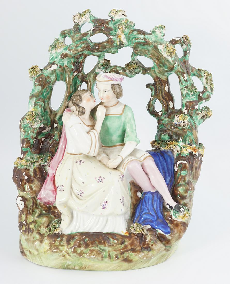 EARLY STAFFORDSHIRE PEARLWARE GROUP: Lovers in a garden, early 19th-century 26 cm. high