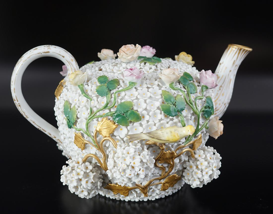 19TH-CENTURY PORCELAIN TEA POT: of bulbous form, with all over raised floral decoration.Meissen cross swords mark to base12 cm. high
