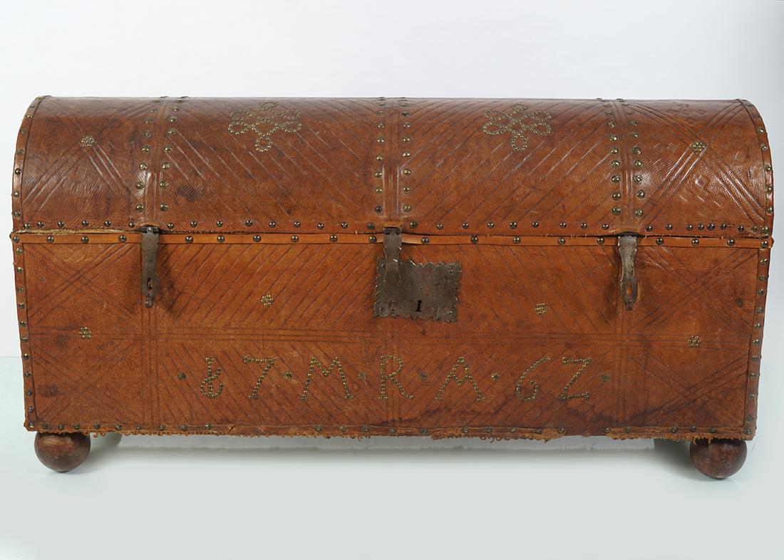 LARGE LEATHER BOUND TRUNK: of rectangular form with a domed lid. 59 cm. high; 115 cm. wide; 36 cm. deep