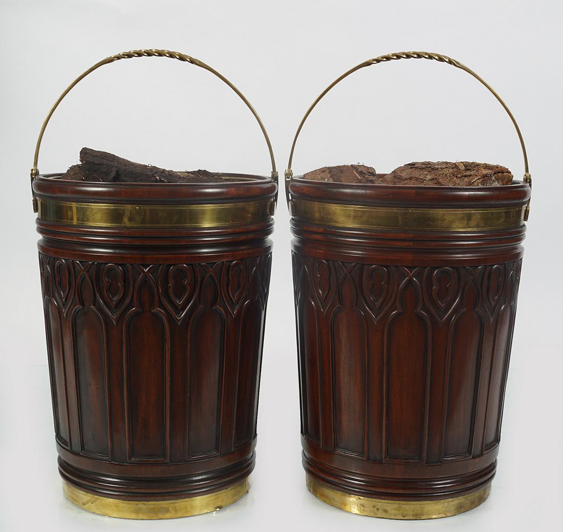 PR. LARGE MAHOGANY AND BRASS BOUND PEAT BUCKETS: each with a tapered Gothic panelled body furnished with a brass swing handle. 52 cm. high; 39 cm. diameter