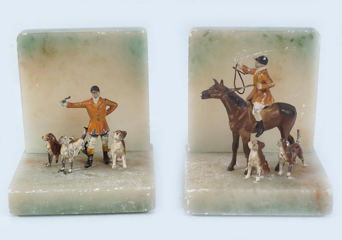 PAIR OF ALABASTER AND COLD PAINTED BOOK ENDS: each with a huntsman and hounds 12 cm. high; 10 cm. wide