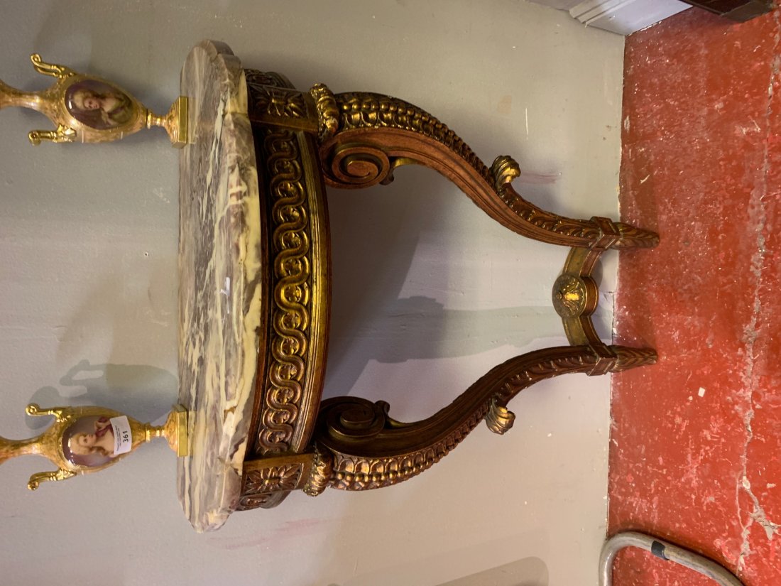 19TH-CENTURY CARVED GILT WOOD CONSOLE TABLE: The demi-lune shaped marble top above a guilloche carved frieze raised on scroll legs to the fore