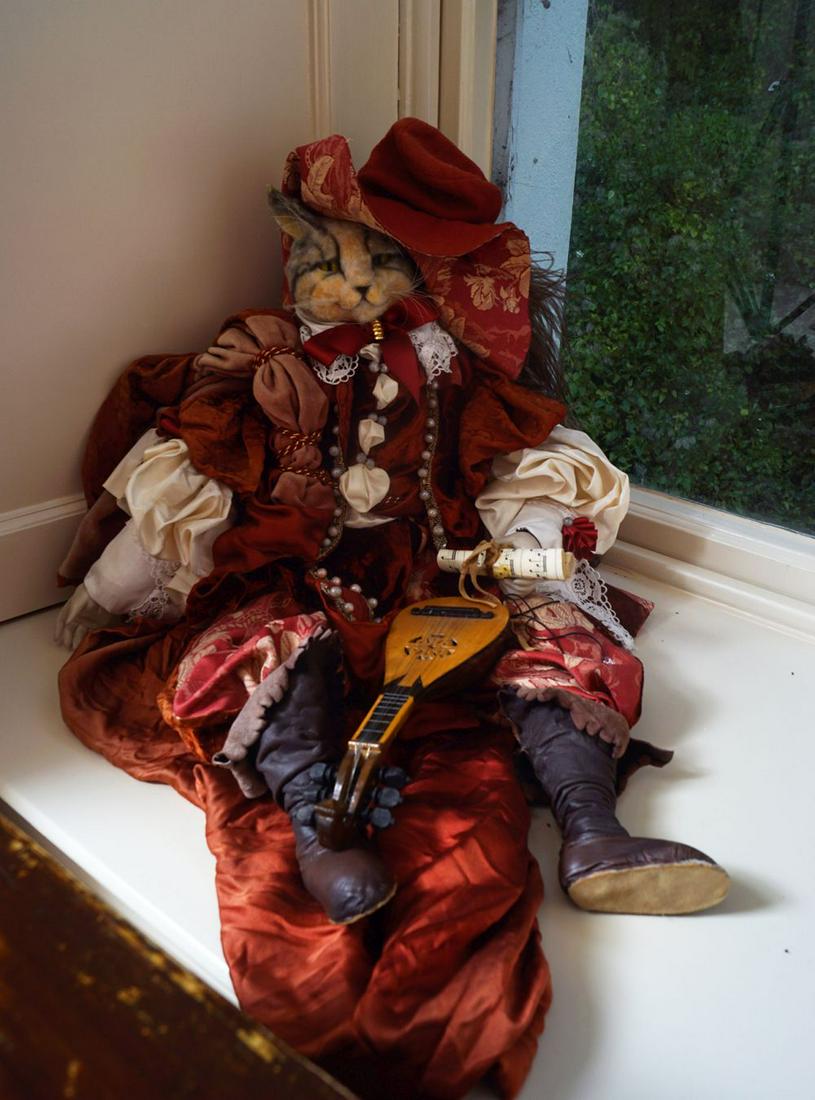 VENETIAN MARIONETTE: Puss in Boots draped in silk and brocade gown with leather boots, porcelain hands holding a scroll and mandolin Provenance: Castlehyde House, Co. Cork, Ireland 72 cm. long