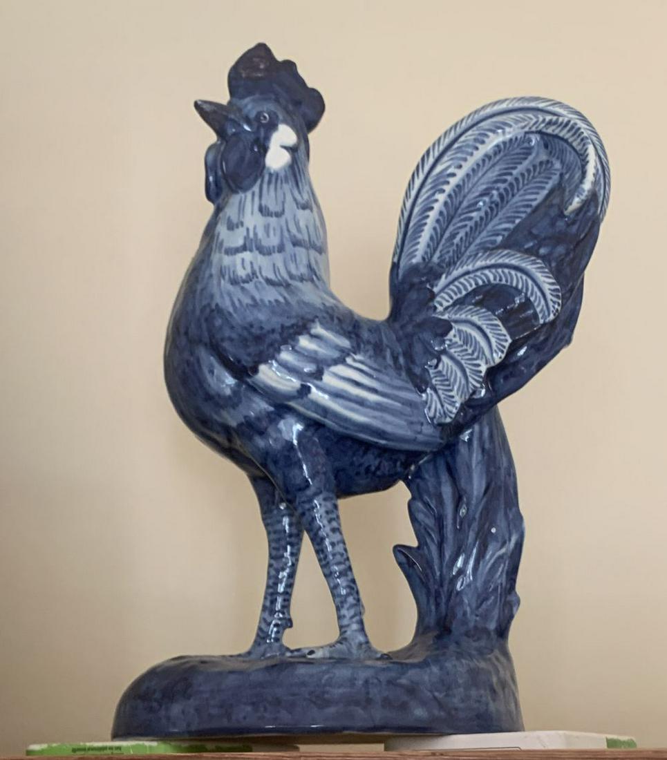 PAIR OF BLUE AND WHITE COCKERELS: each standing on a circular mound 30 cm. high