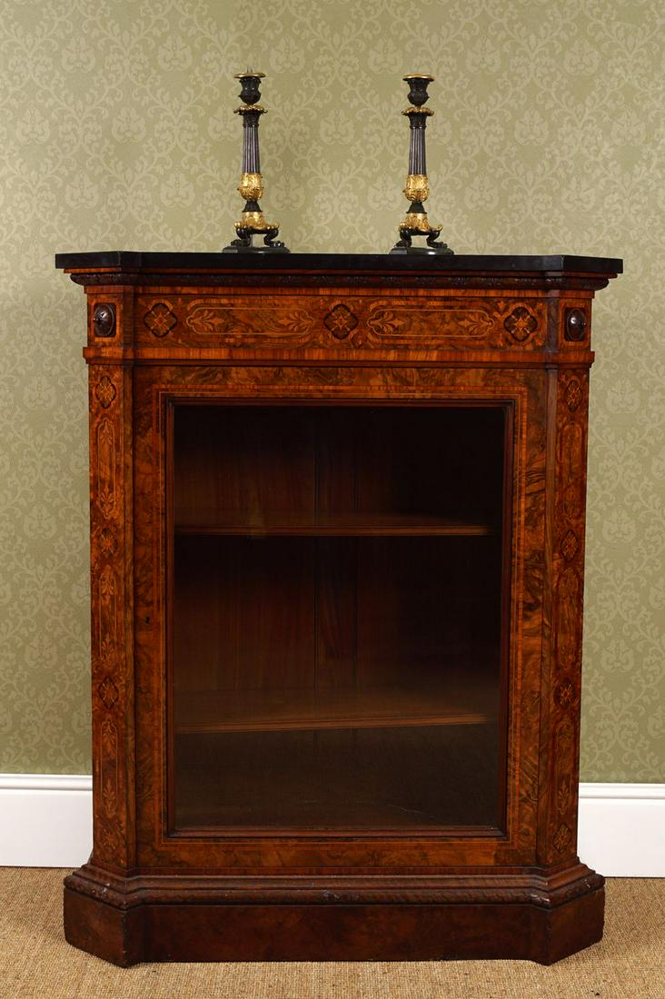 19TH-CENTURY WALNUT AND MARQUETRY PIER CABINET: the rectangular marble top above a profusely inlaid frieze, above a glazed panelled door, raised on a square chamfered base. 90 cm. high; 80 cm. wide