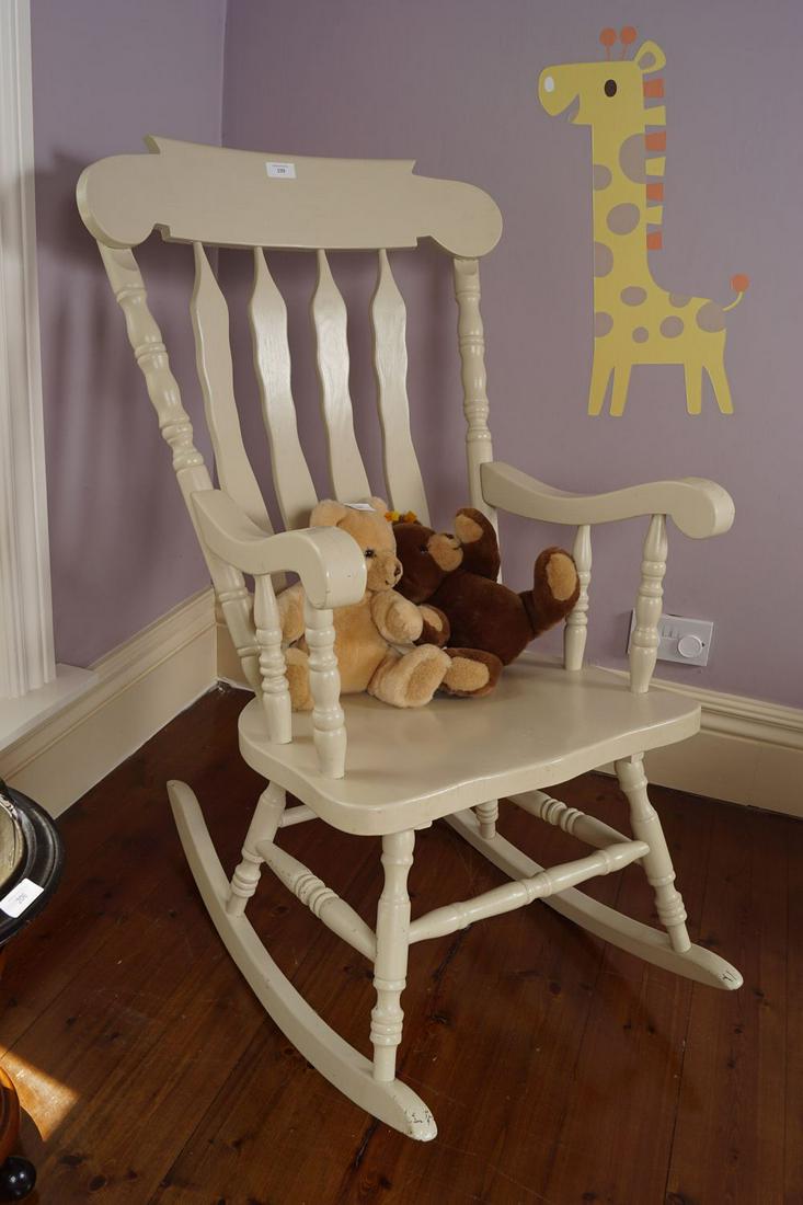 ROCKING CHAIR: with railed back and panelled seat, raised on hooped supports approx. 100 cm. high; 50 cm.wide; 40 cm. deep