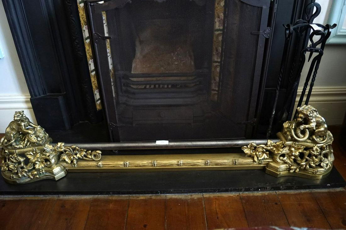 19TH-CENTURY FRENCH BRASS AND STEEL FIRE FENDER: with lion and prey sculpted ends 26 cm. high; 130 cm. wide