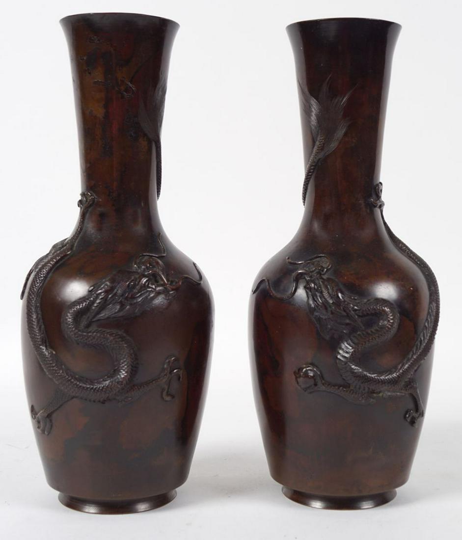 PAIR OF JAPANESE MEIJI BRONZE VASES: each of baluster form with raised dragon decoration 31 cm. high