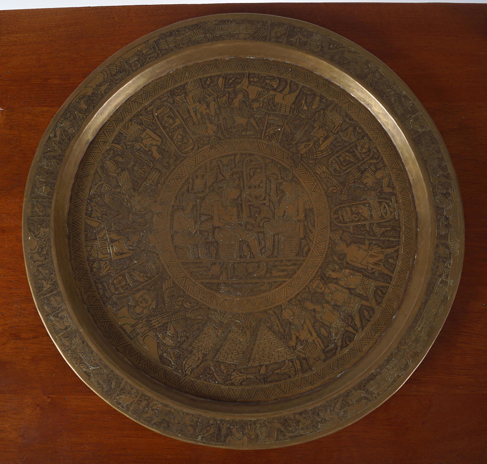 18TH-CENTURY CAIRO BRONZE SALVER: the central roundel depicting Pharaoh Isis Horus and others. 34 cm. diameter
