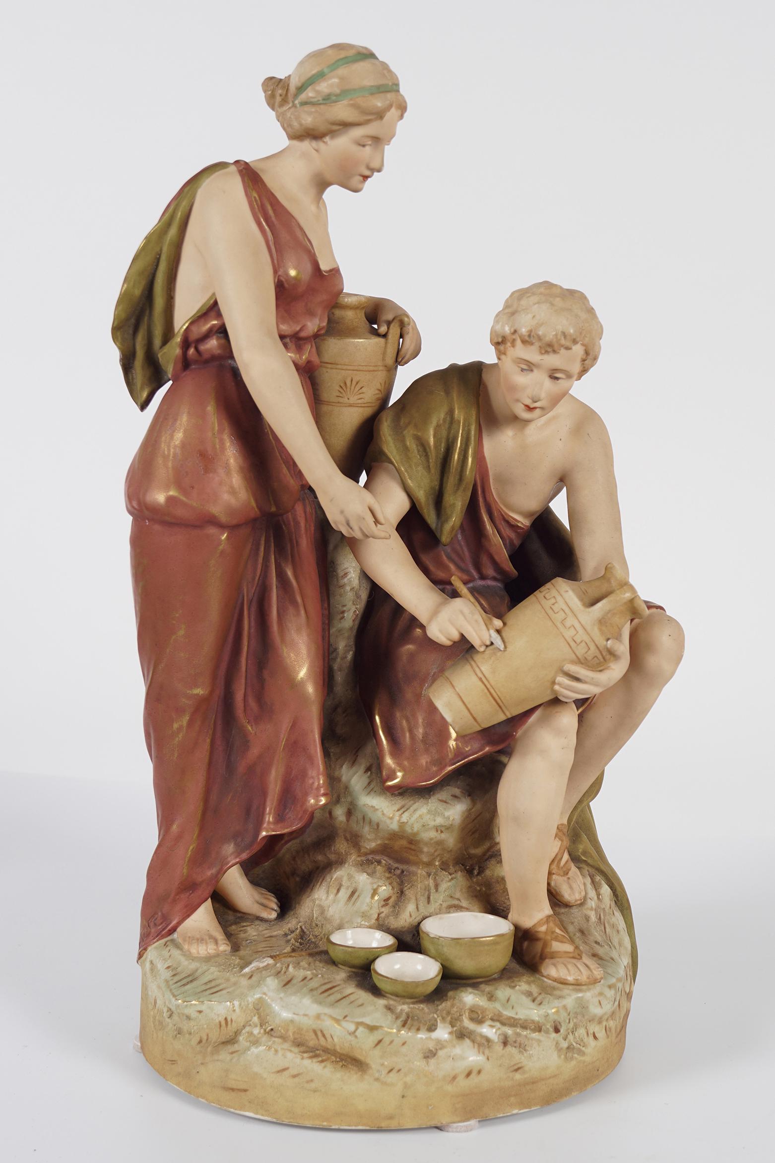 ROYAL DUX PORCELAIN GROUP: Figures at a well. 46 cm. high; 25 cm. wide; 17 cm. deep