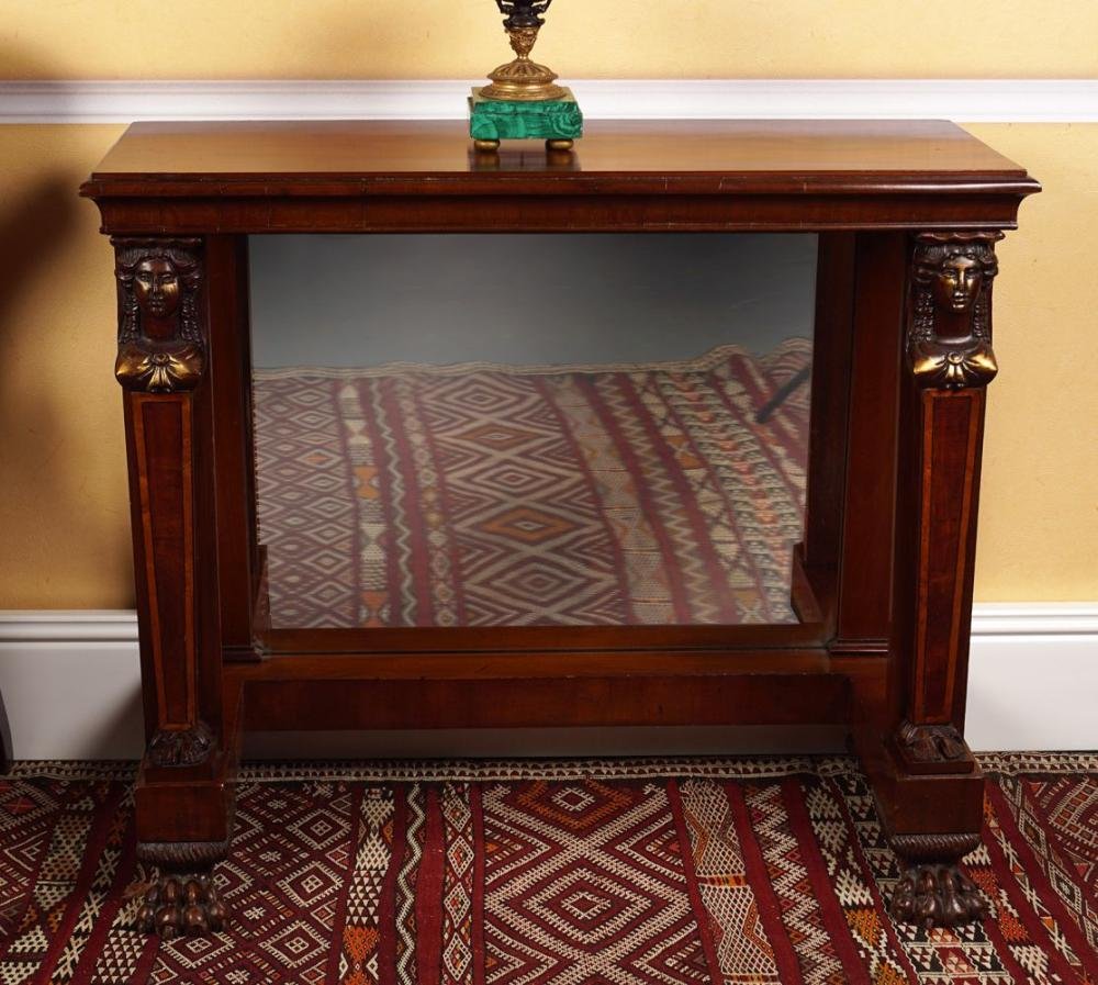 PAIR OF 19TH-CENTURY MAHOGANY CONSOLE TABLES: each with a rectangular moulded edged top above a cavetto moulded frieze, raised on figure headed tapered legs to the fore, supported on an inverted breakfront platform base, terminating on claw feetD