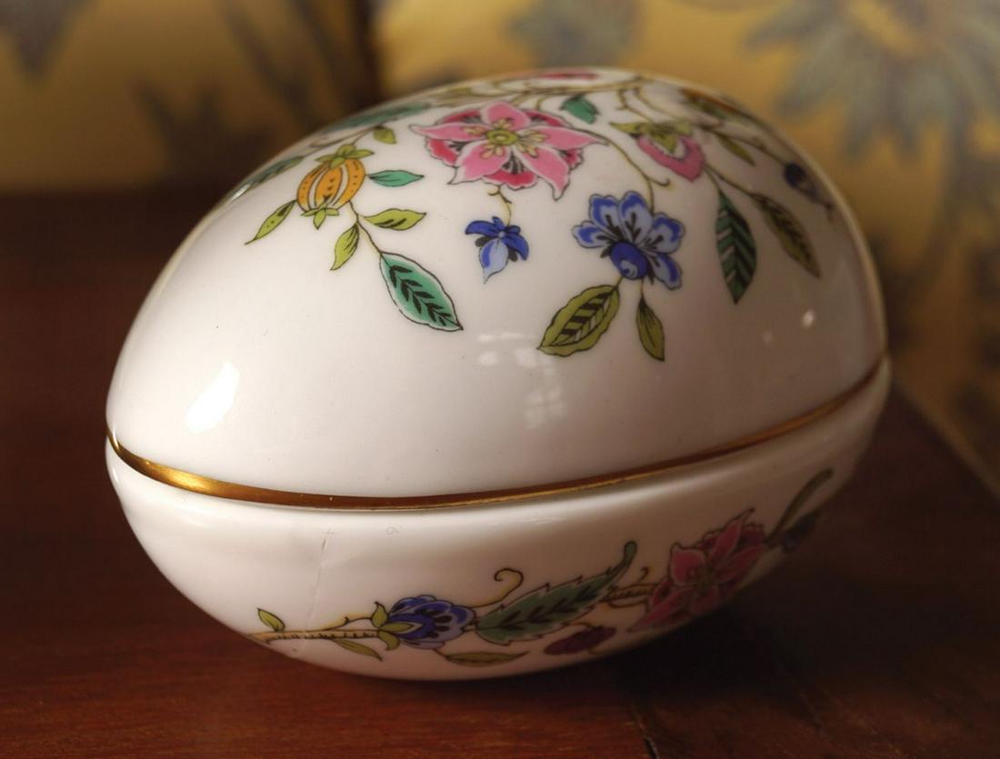 MINTON CHINA BOX AND COVER: of egg shape, with floral decoration. 6 cm. high